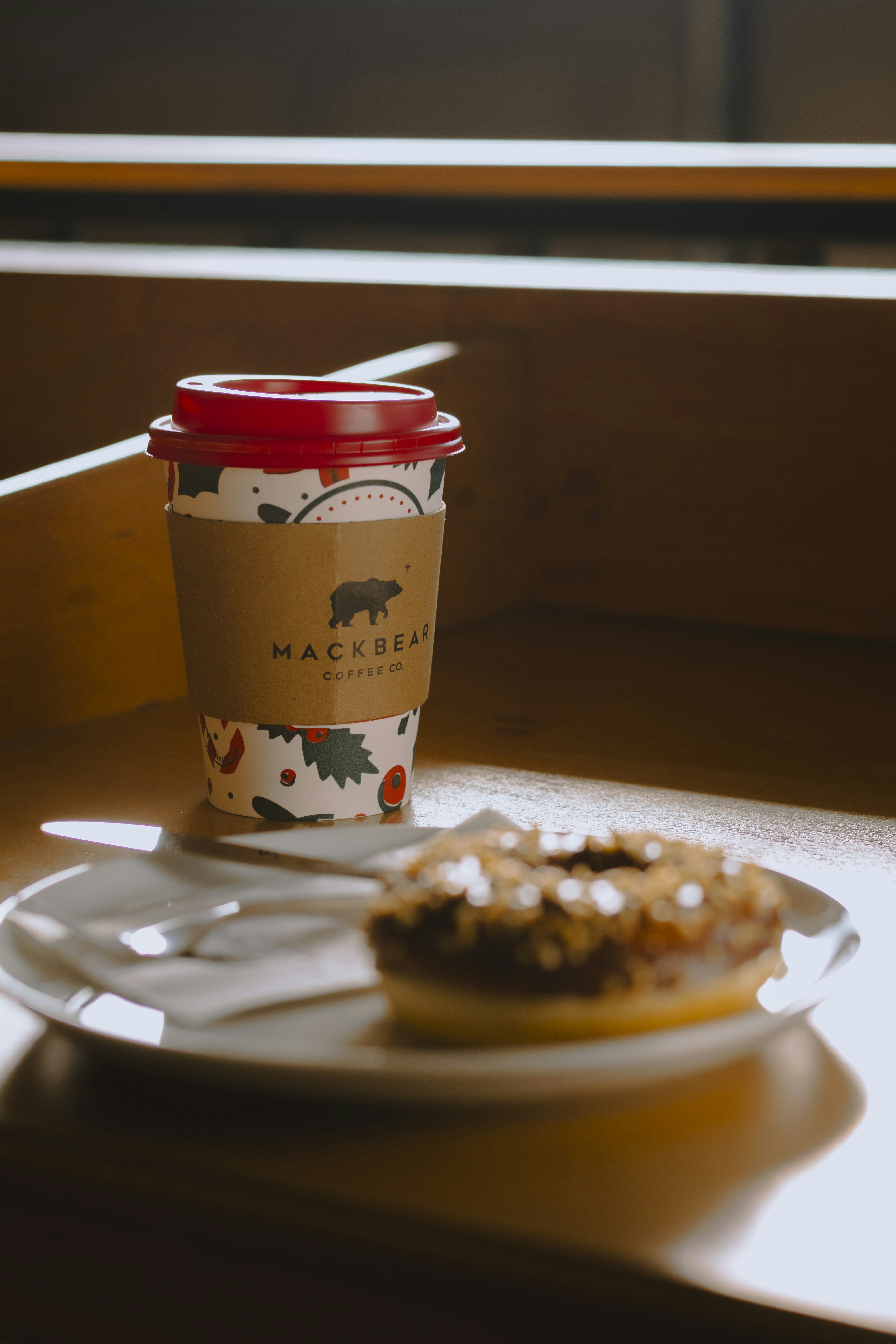 Coffee cup and donut on a plate