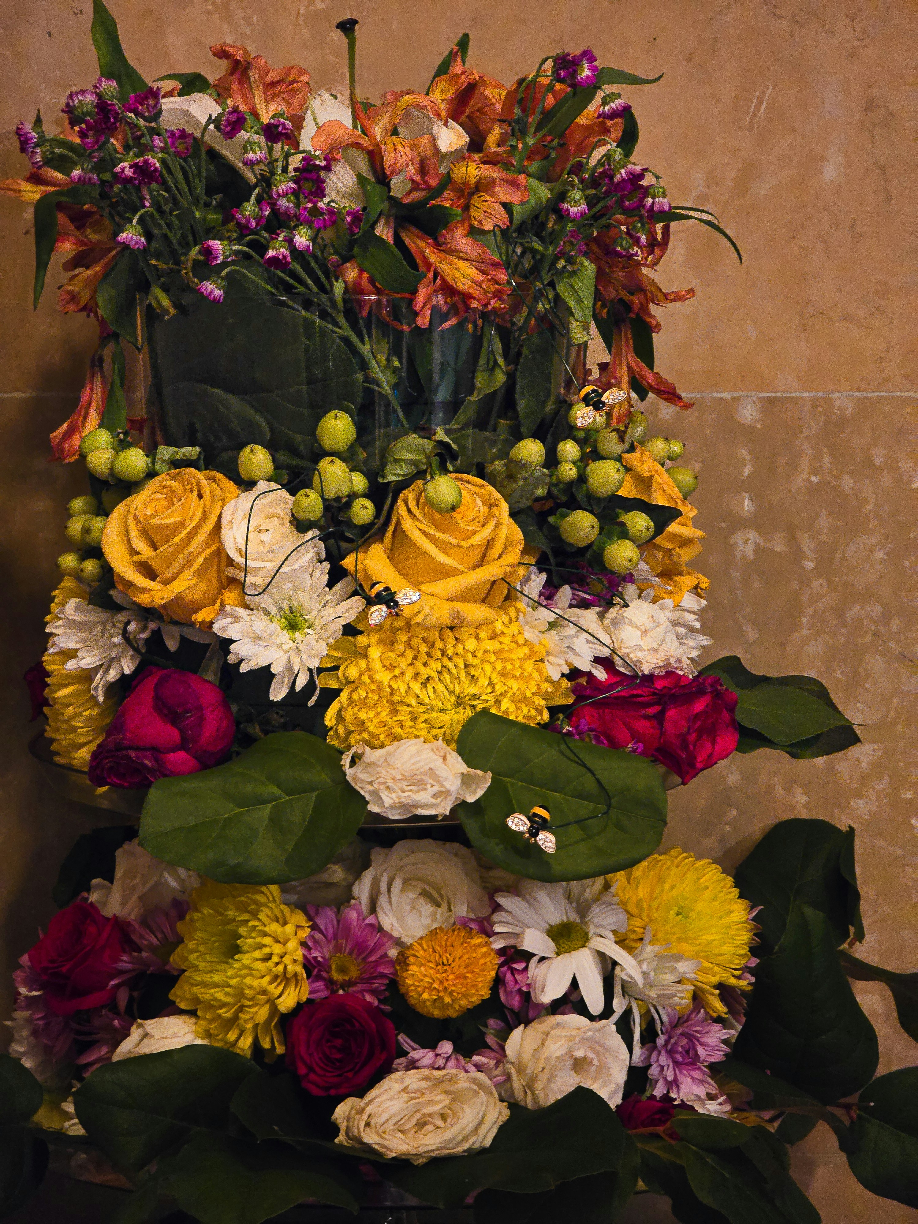 A vibrant arrangement of colorful flowers with yellow roses.
