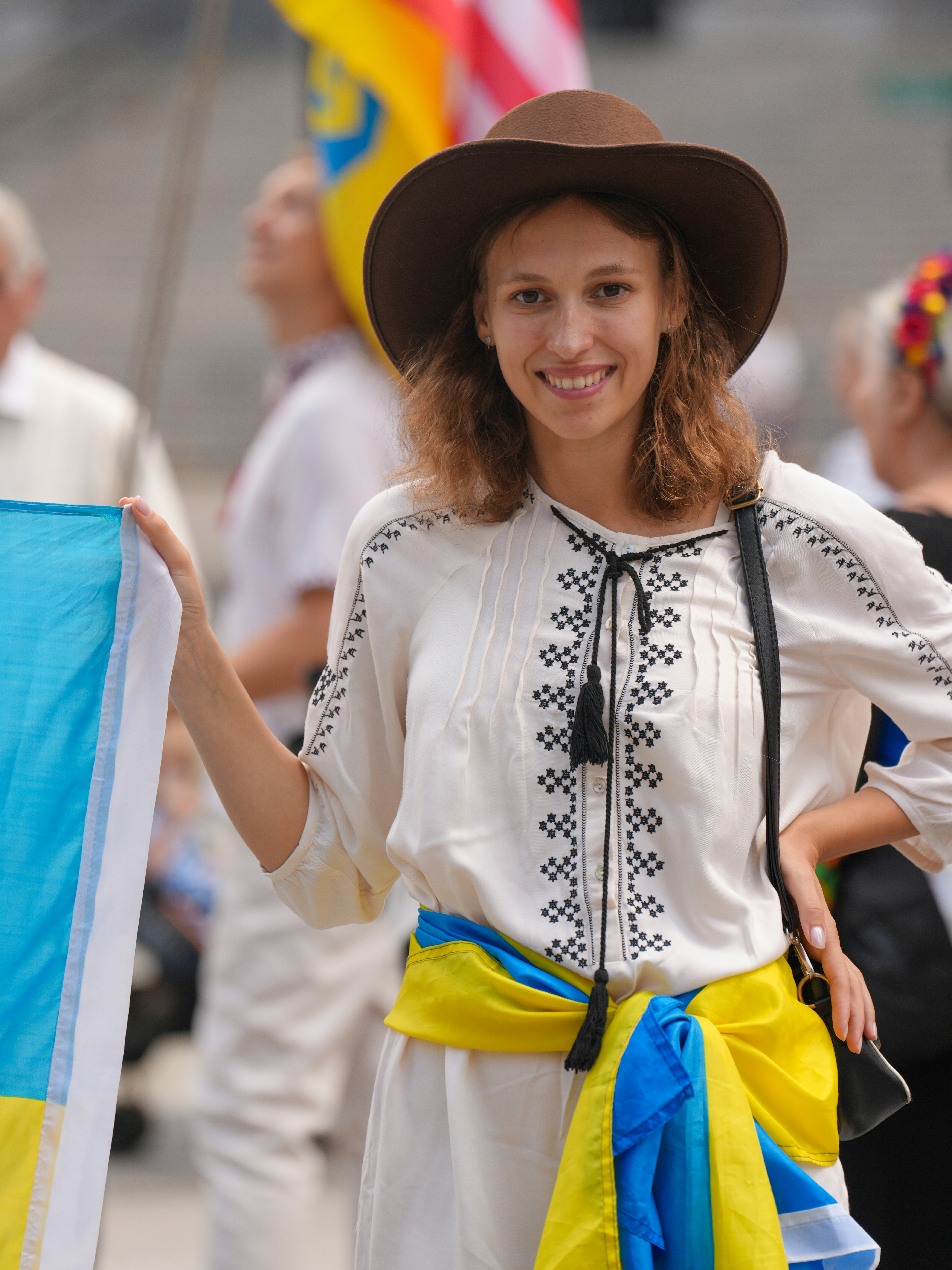 Woman in traditional clothing holding ukrainian flag
