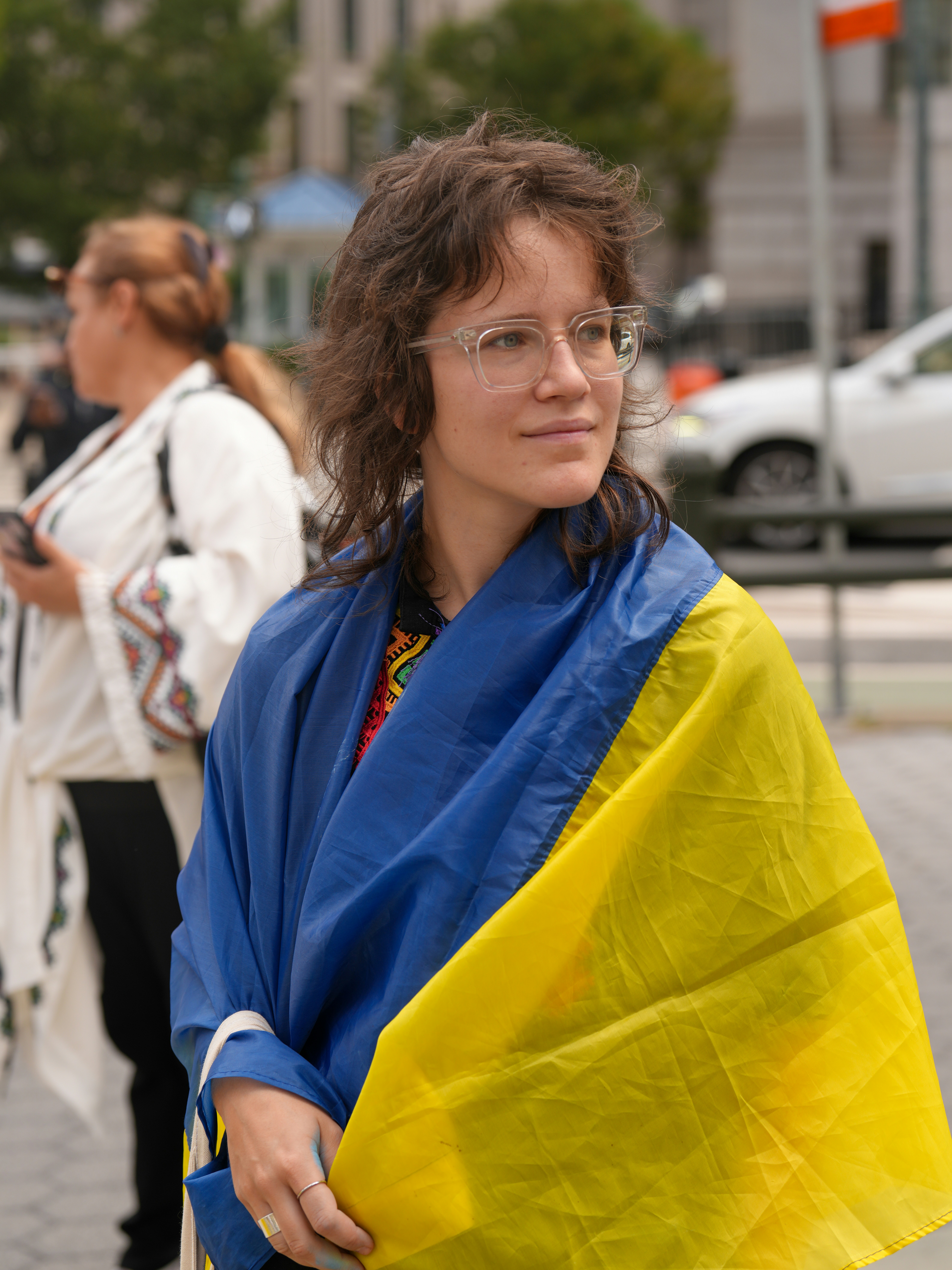 Woman draped in ukrainian flag with glasses