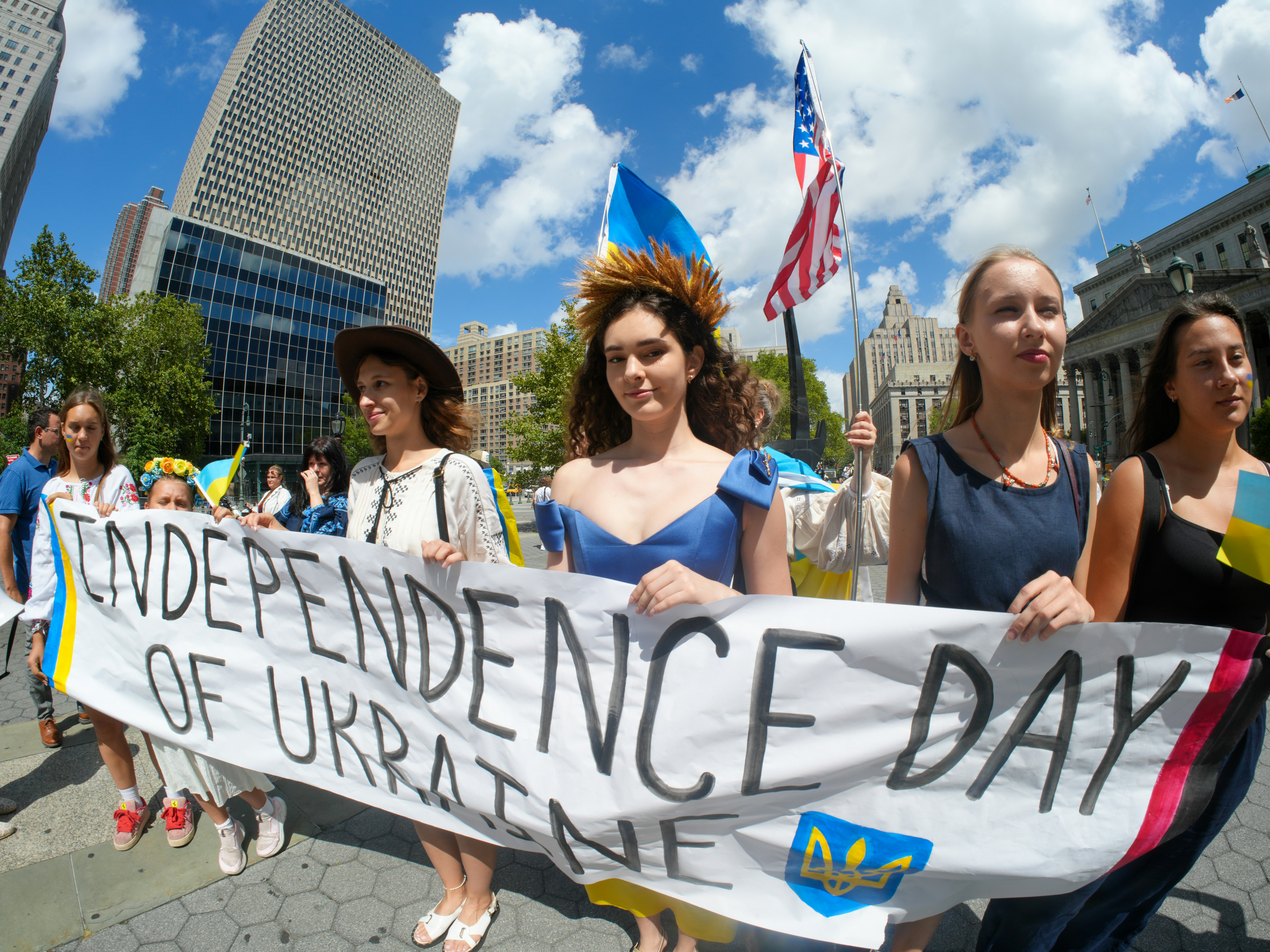 People march holding a banner for ukraine's independence day.