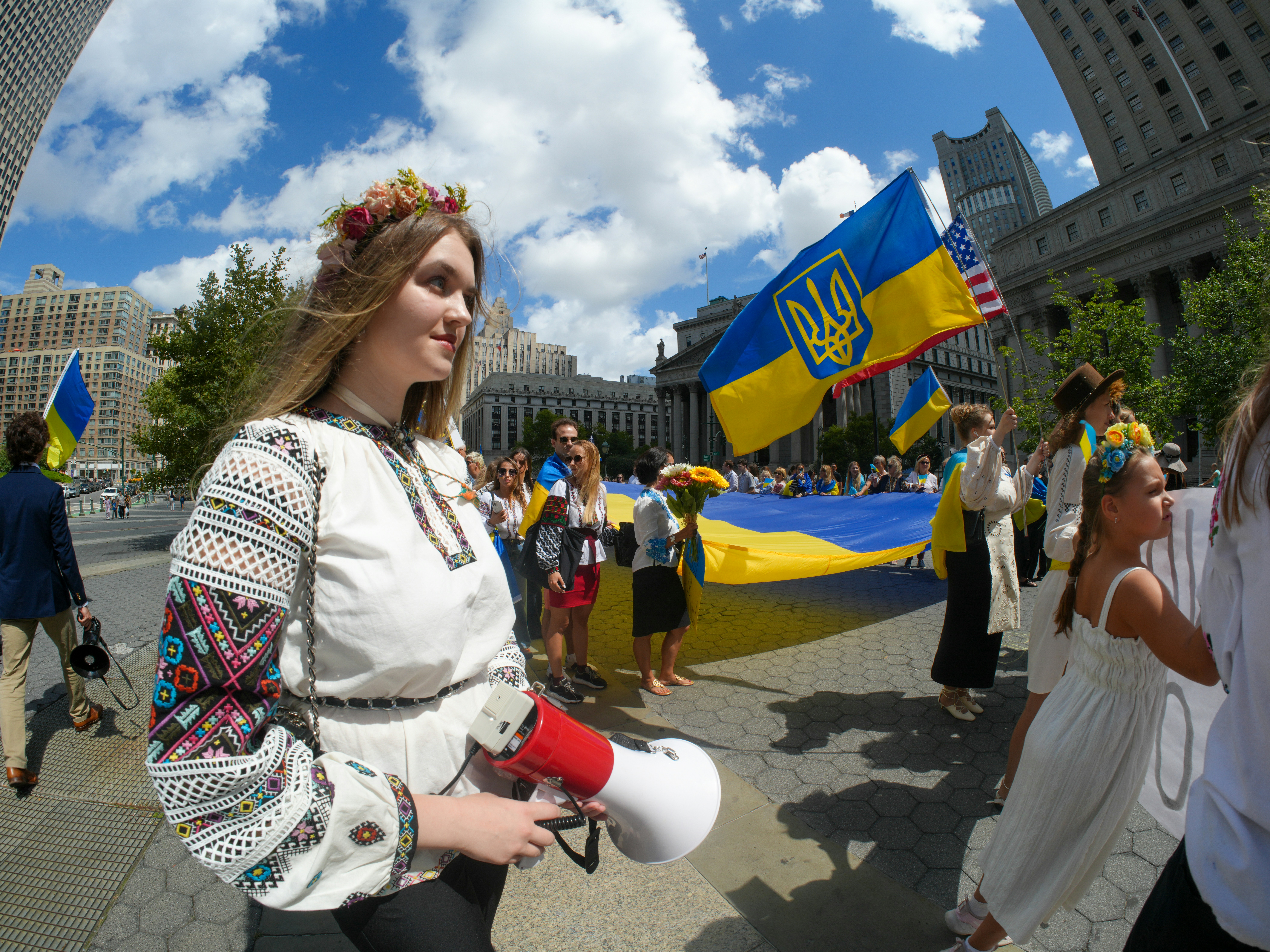 Young woman in traditional ukrainian clothing holding megaphone