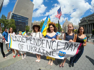 People hold banner celebrating independence day of ukraine.