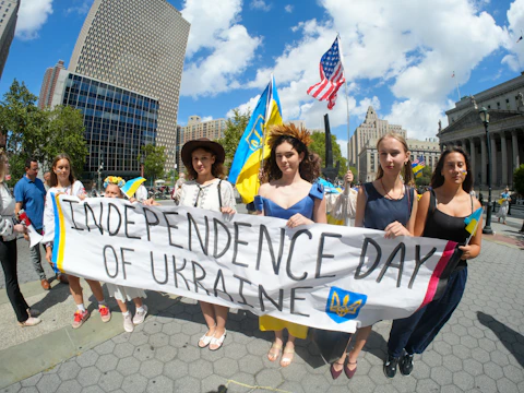 People hold banner celebrating independence day of ukraine.