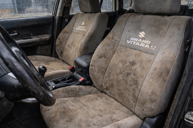 Car interior with dirty stained seats and heavy contamination before deep detailing