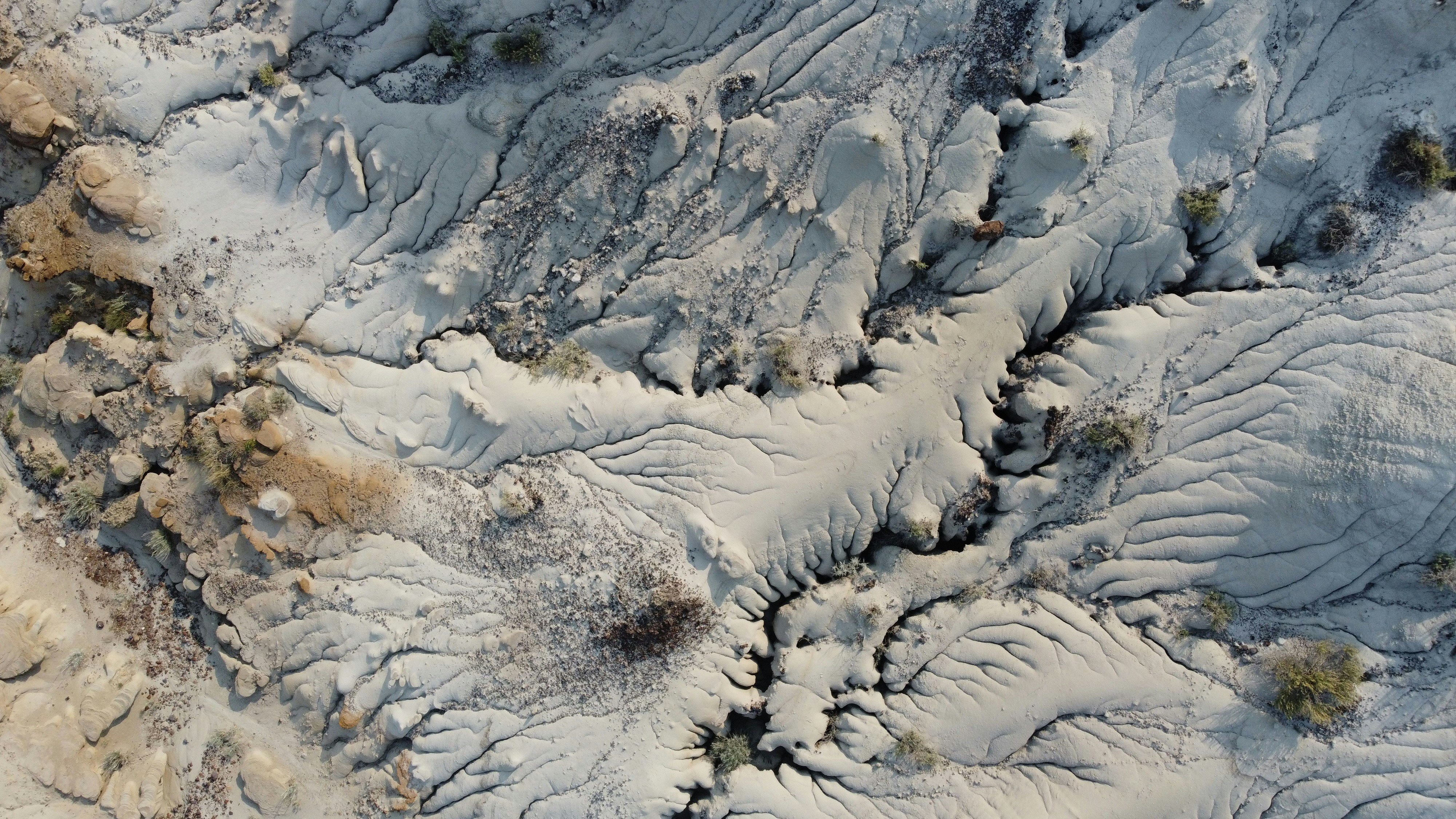 Aerial view of arid desert badlands with erosion patterns