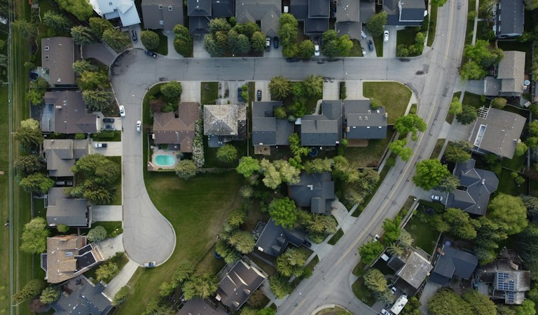 Aerial view of a suburban subdivision with rows of houses and curving streets