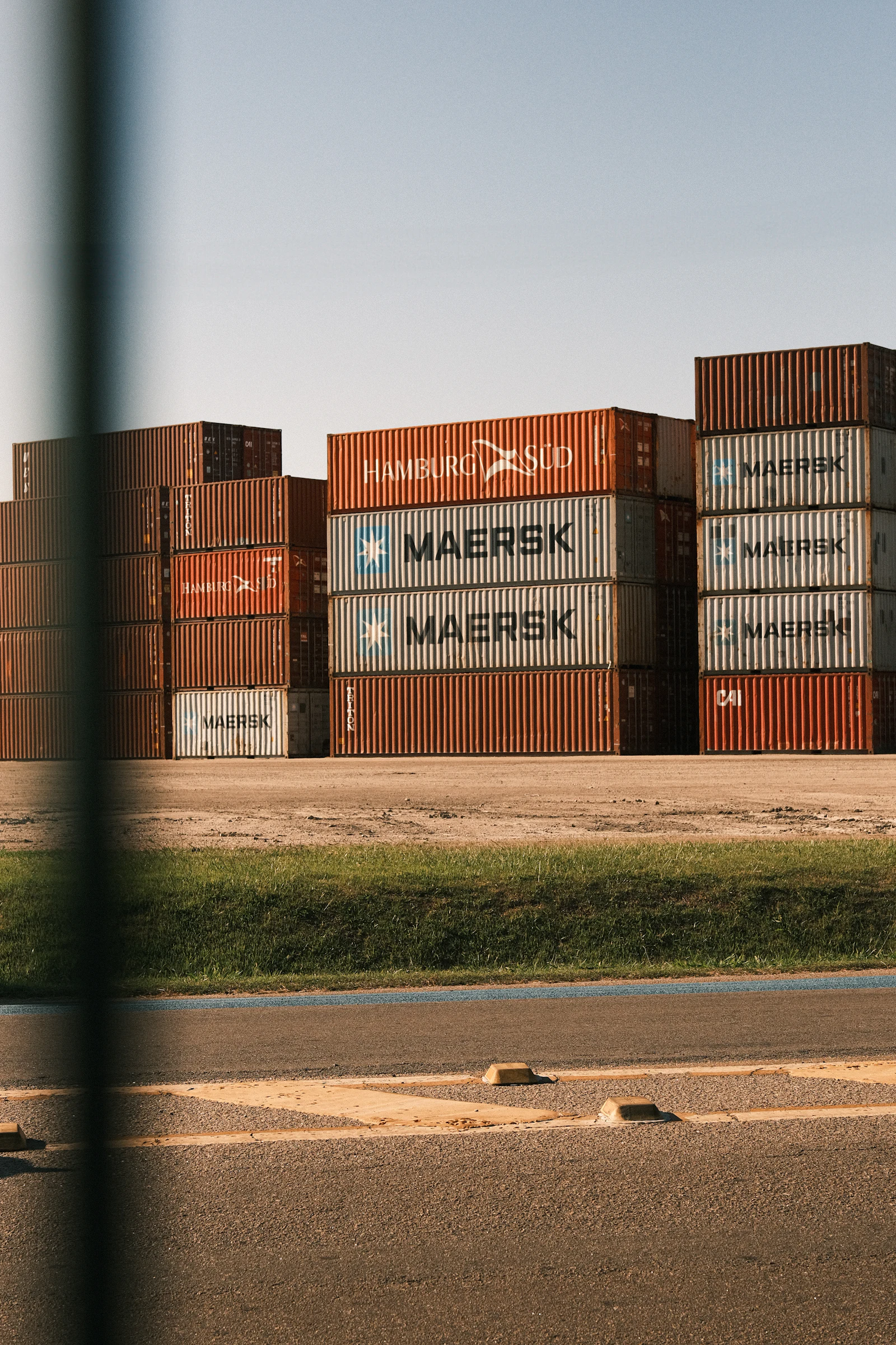 Stacks of shipping containers at a port, row upon row.