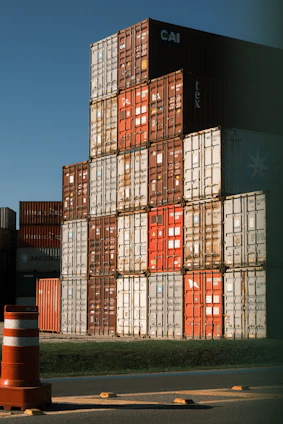 Stack of colorful shipping containers under a clear blue sky