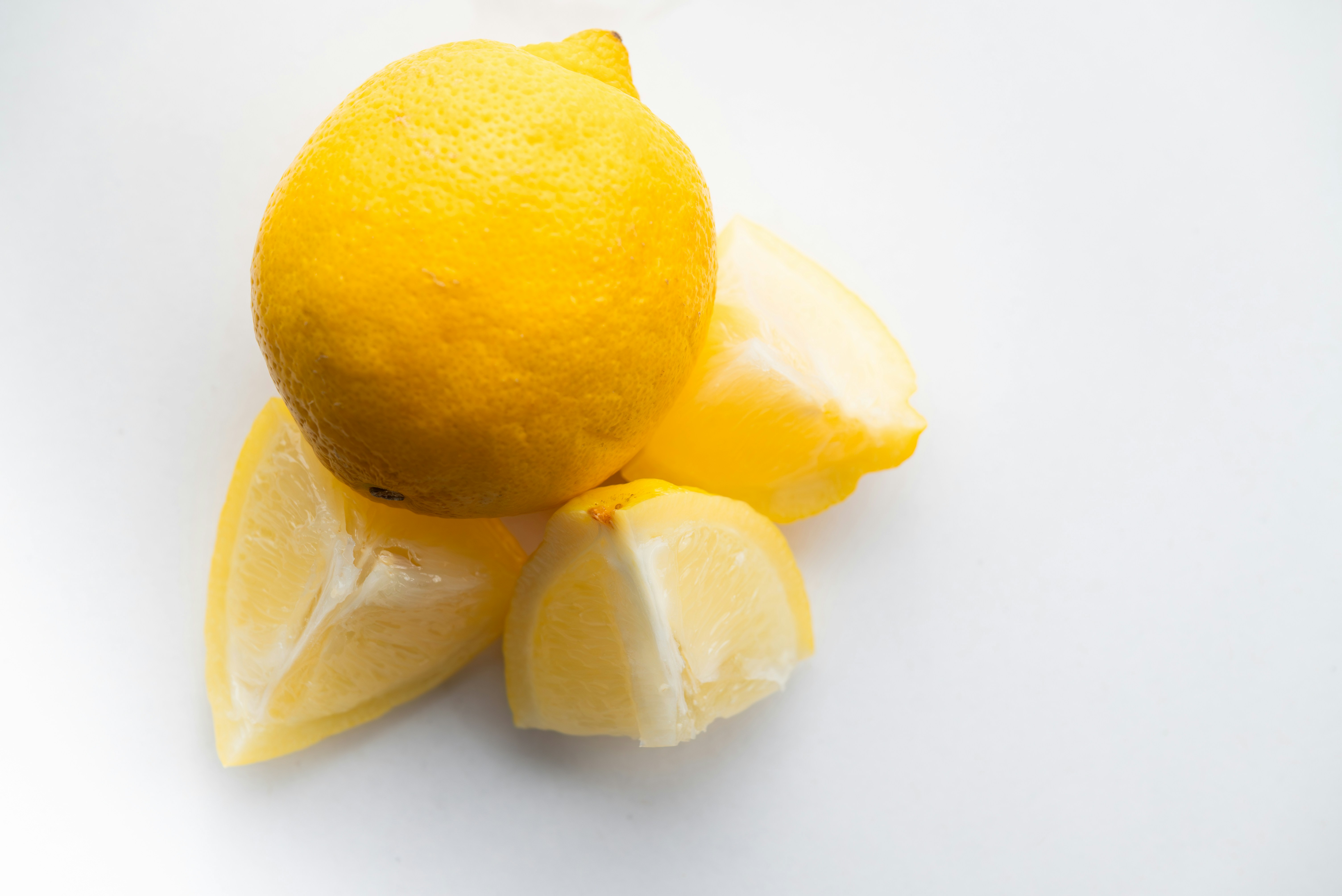 Several ripe lemons on a white surface