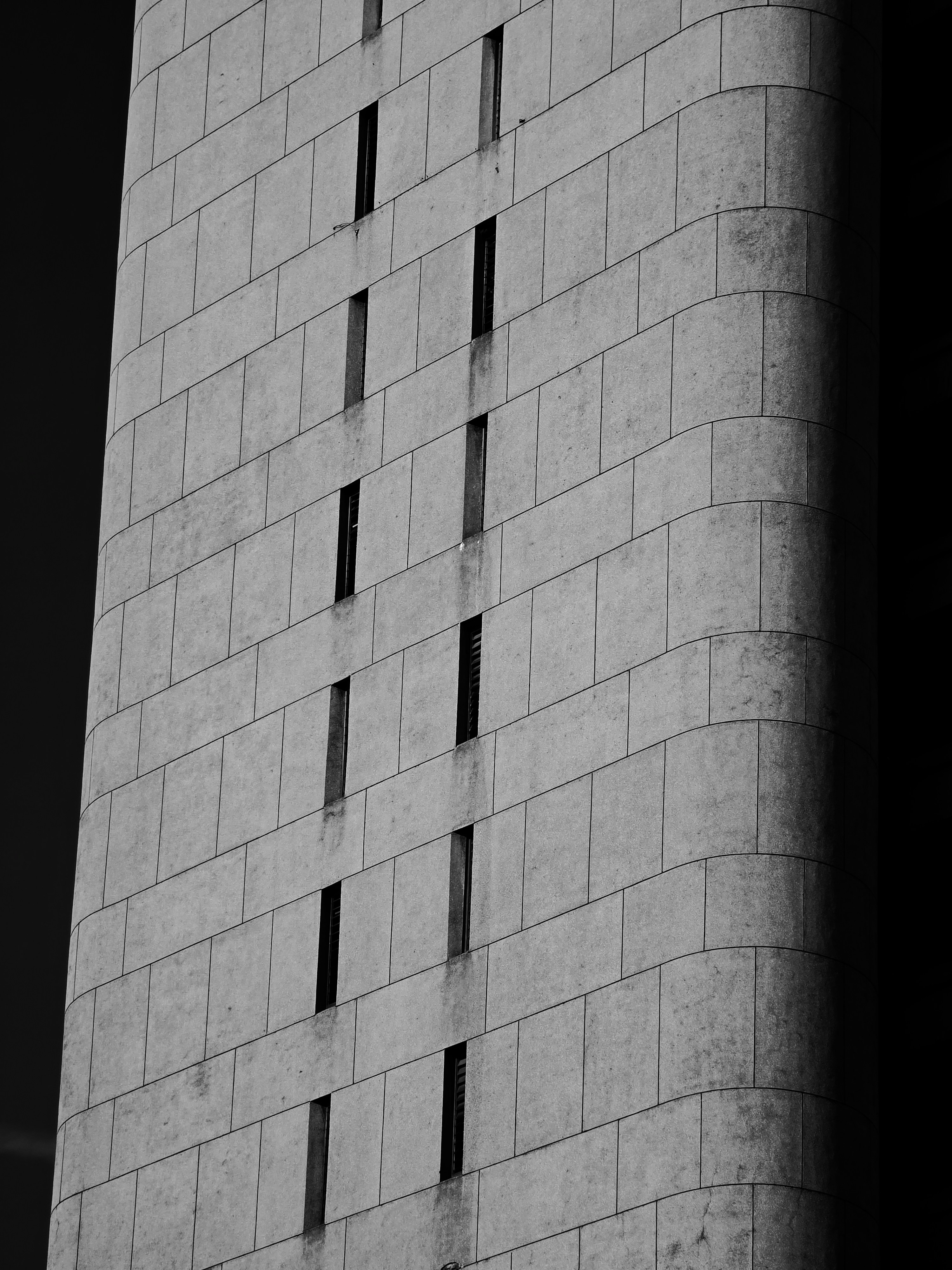 A tall concrete building with many windows