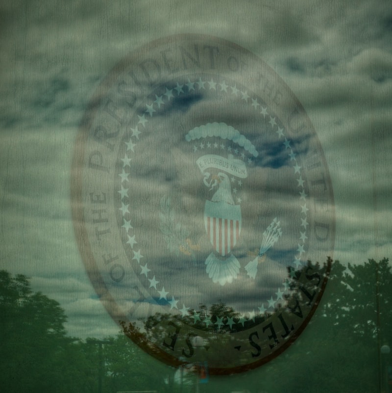 Presidential seal of the United States superimposed on a cloudy sky