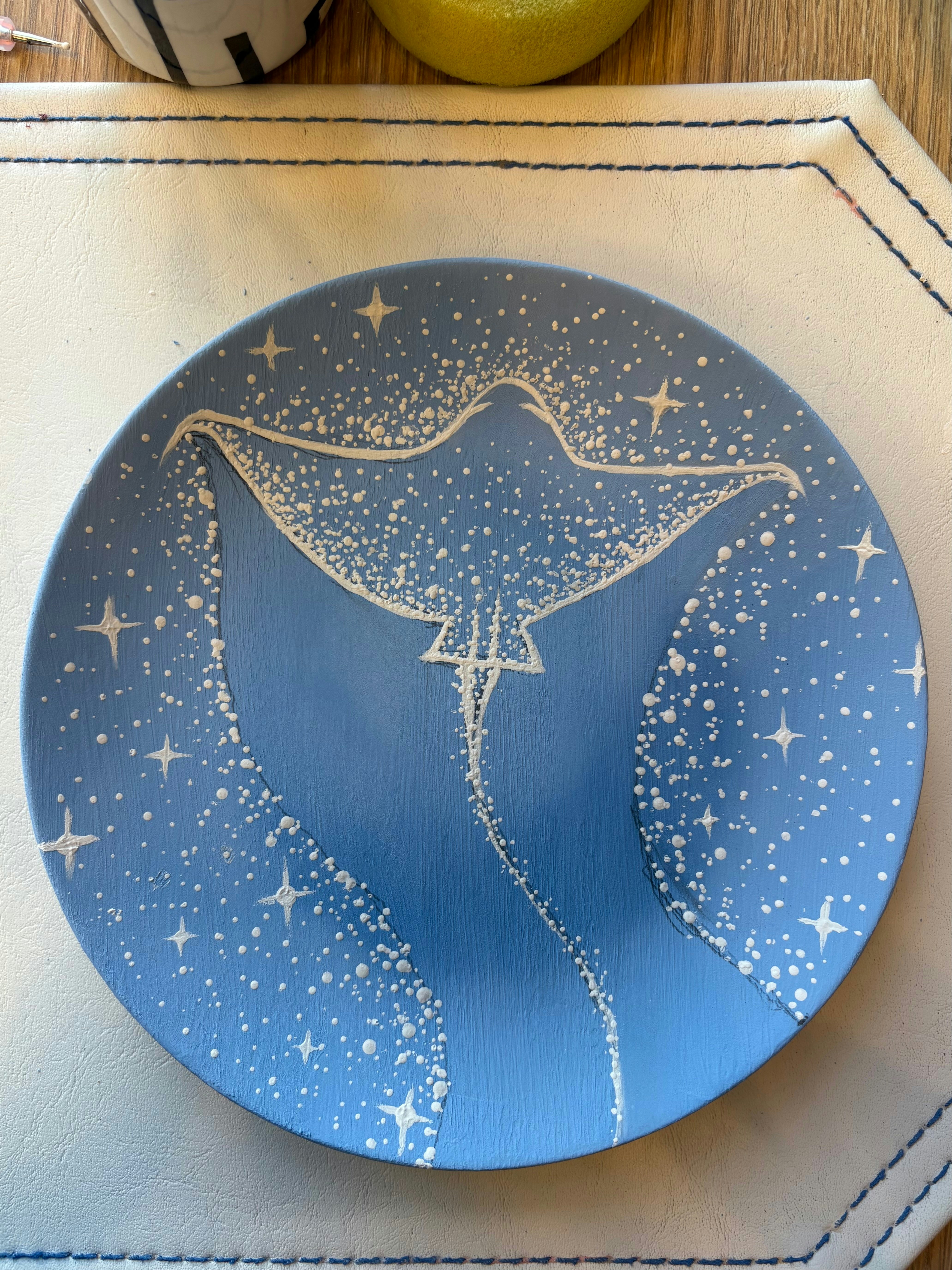 A blue plate with a stingray and stars design
