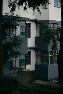 Modern apartment building with dark grey accents and trees