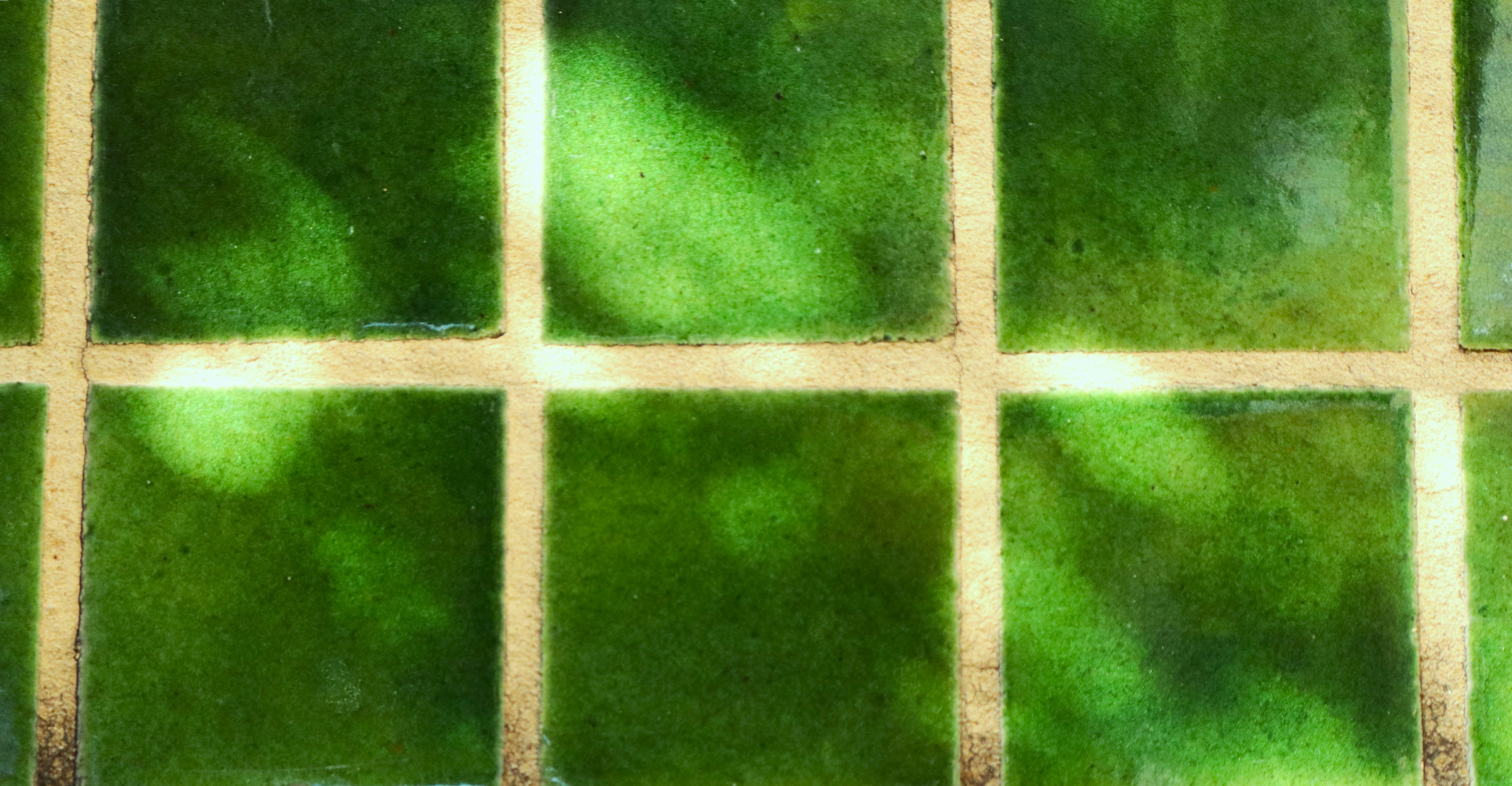 Green tiles with a grid pattern and shadows