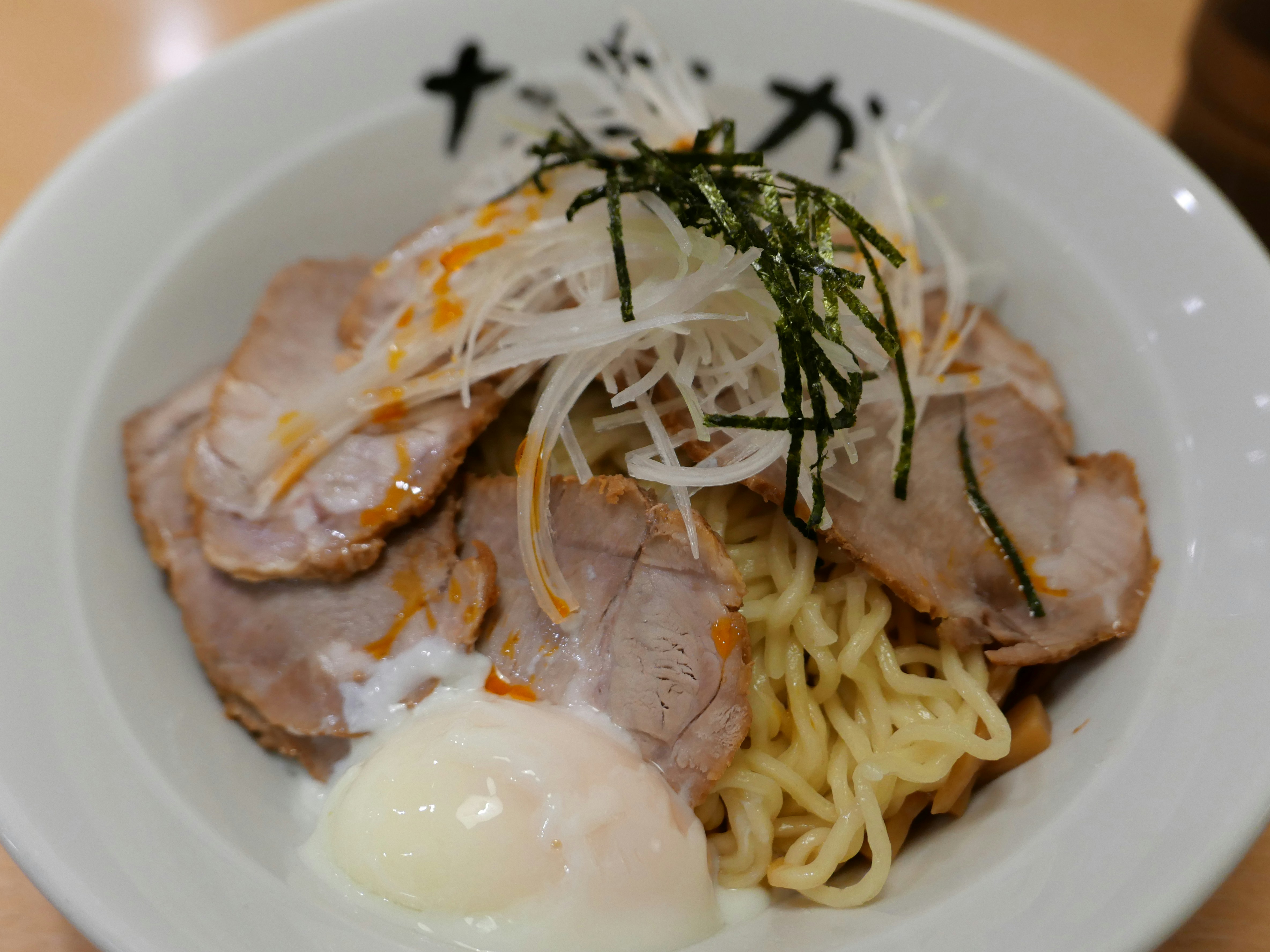 Ramen with sliced pork, egg, and green onions.