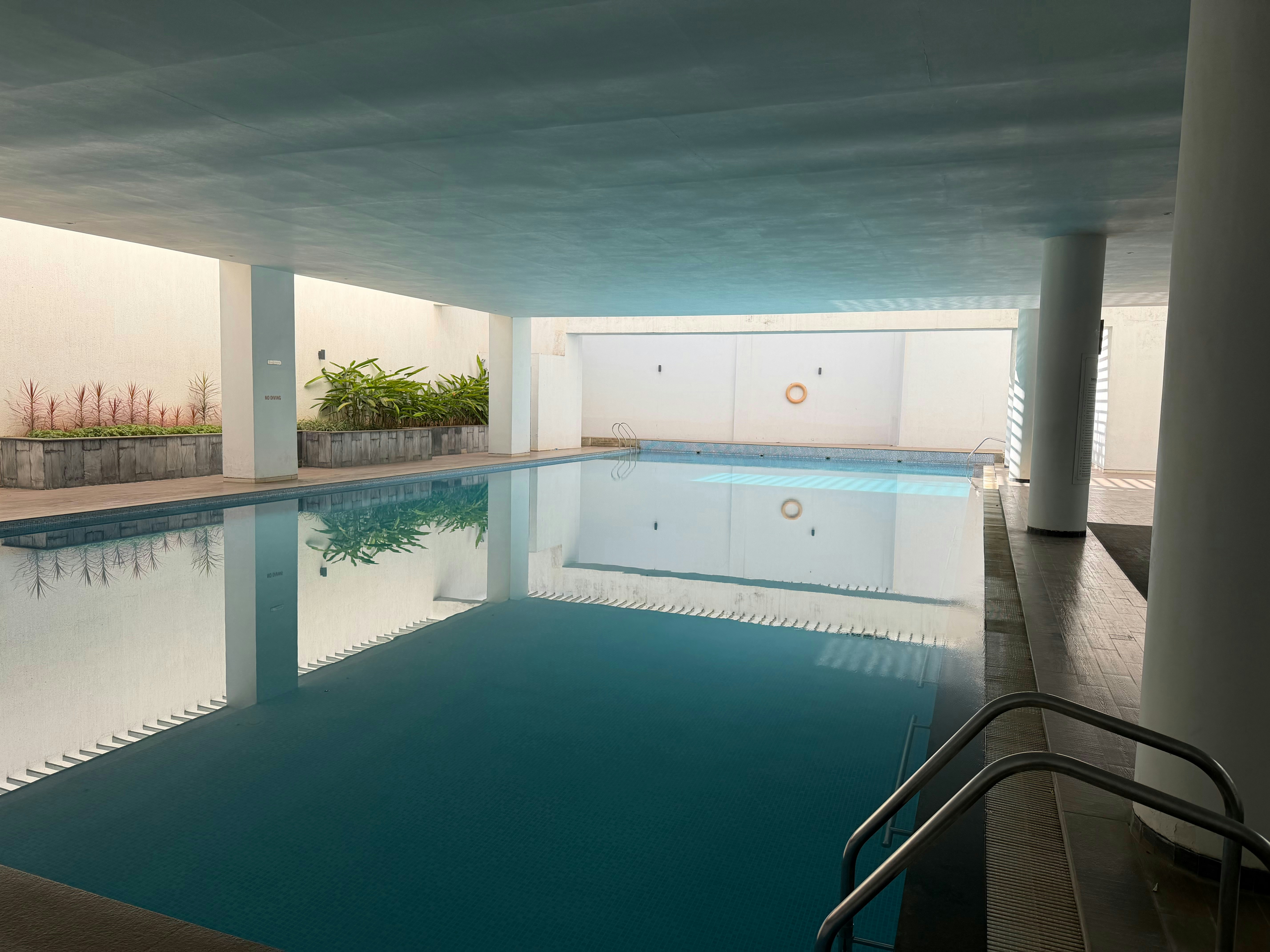 Indoor swimming pool with clear blue water.