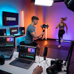 Fitness influencers filming workout in studio with professional equipment