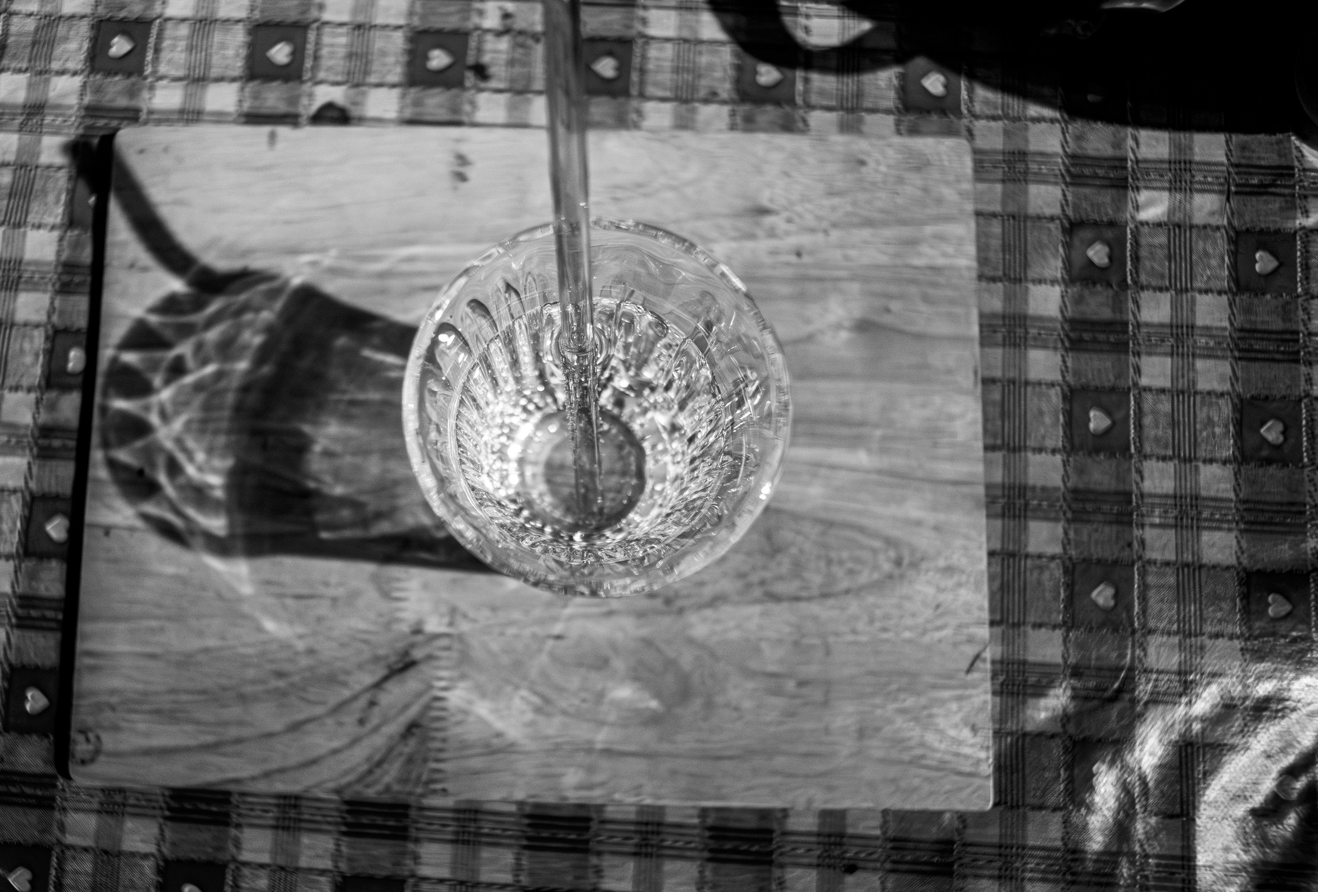 Glass bowl with spoon on wooden board