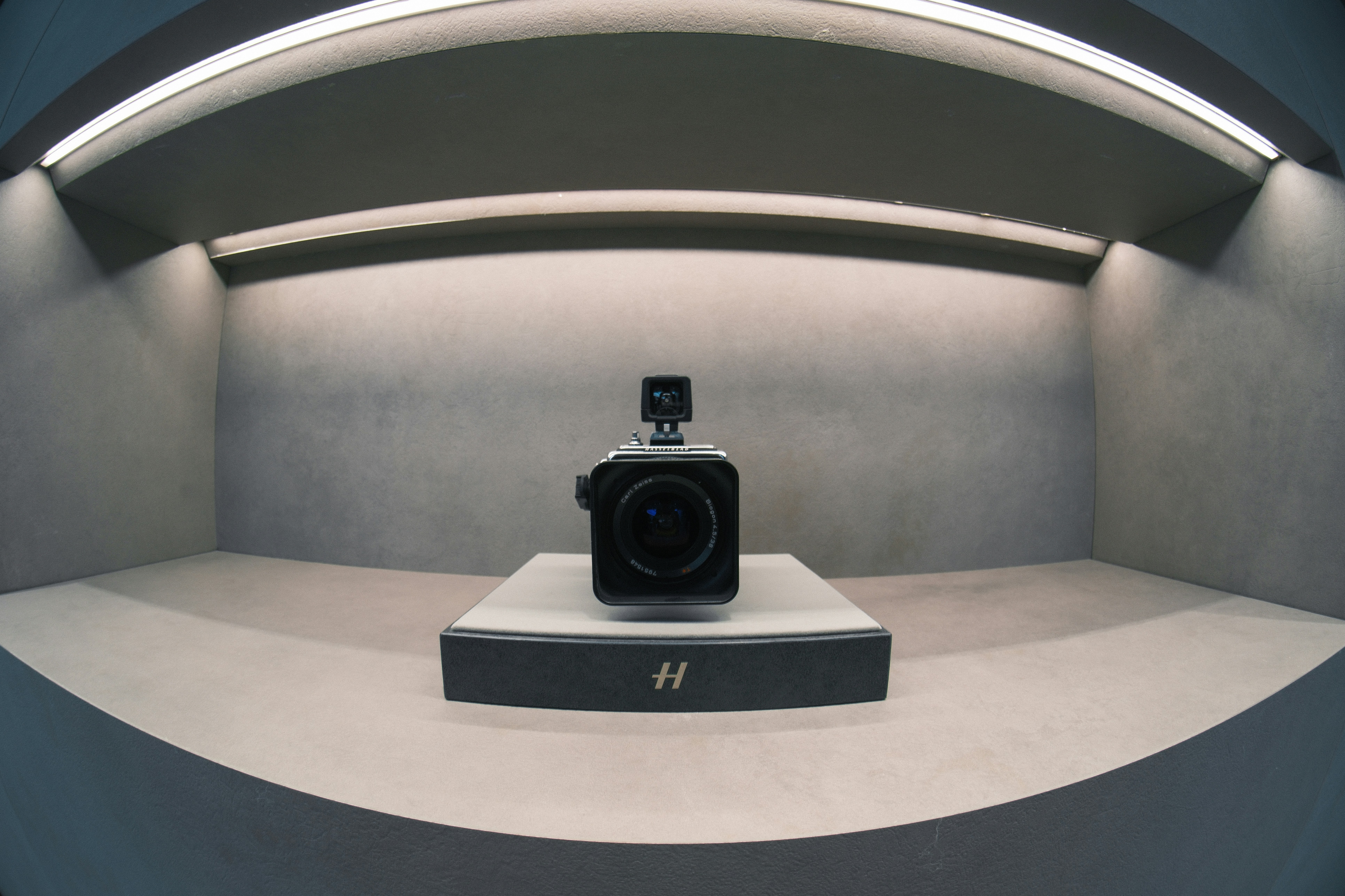 A professional camera displayed on a stand.