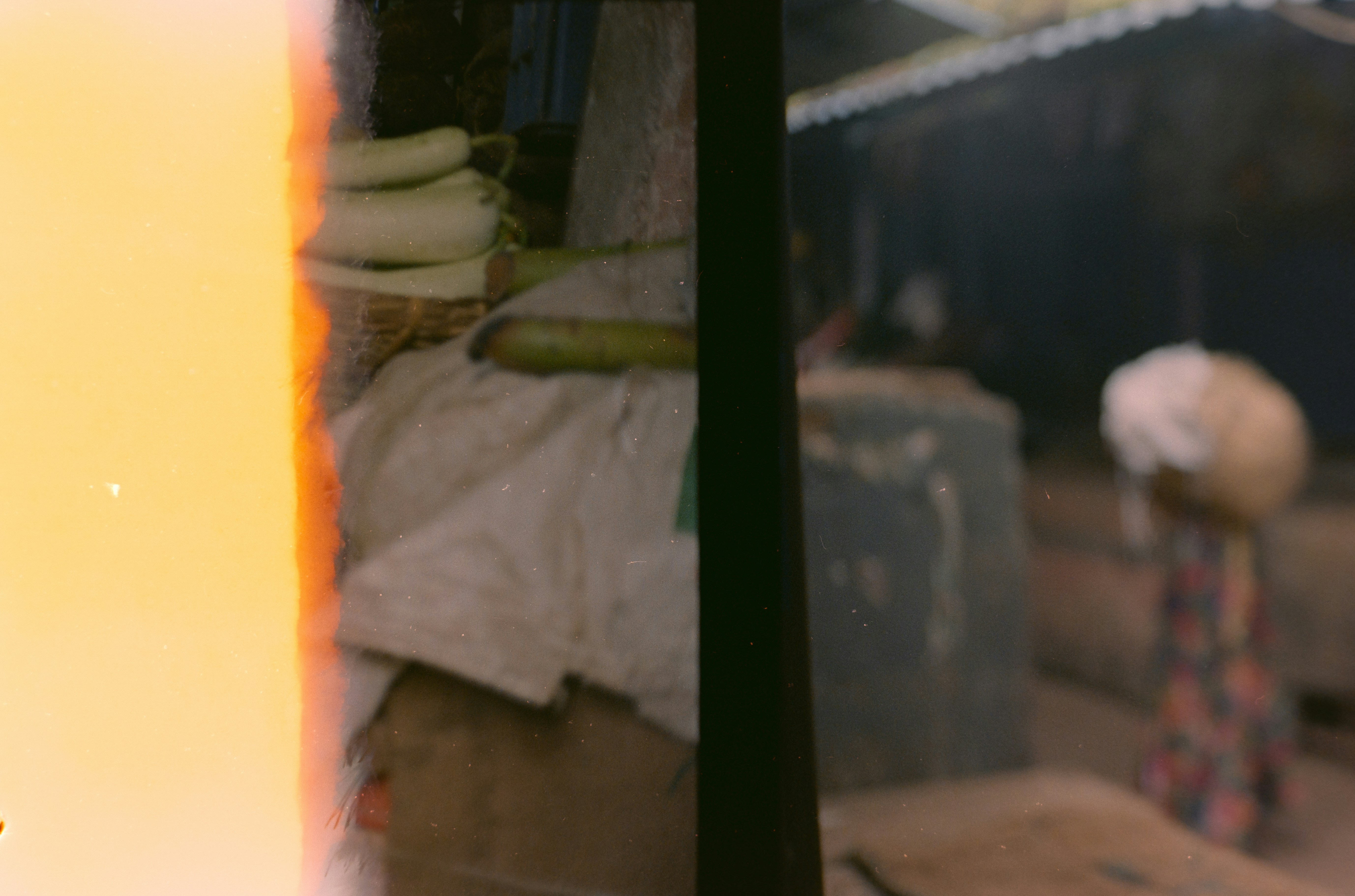 Person carrying a large bundle on head outdoors