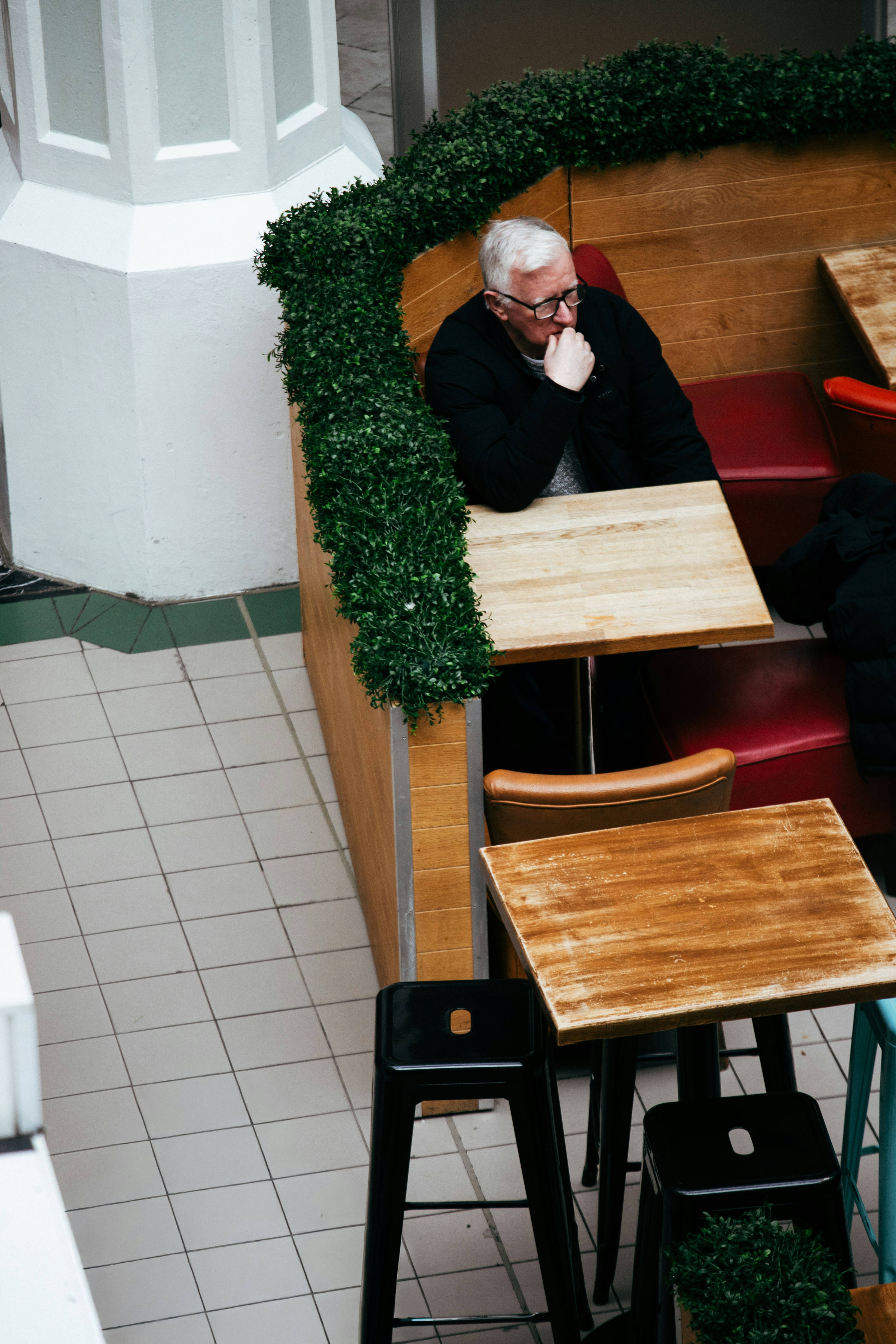 Man sitting alone at a cafe booth