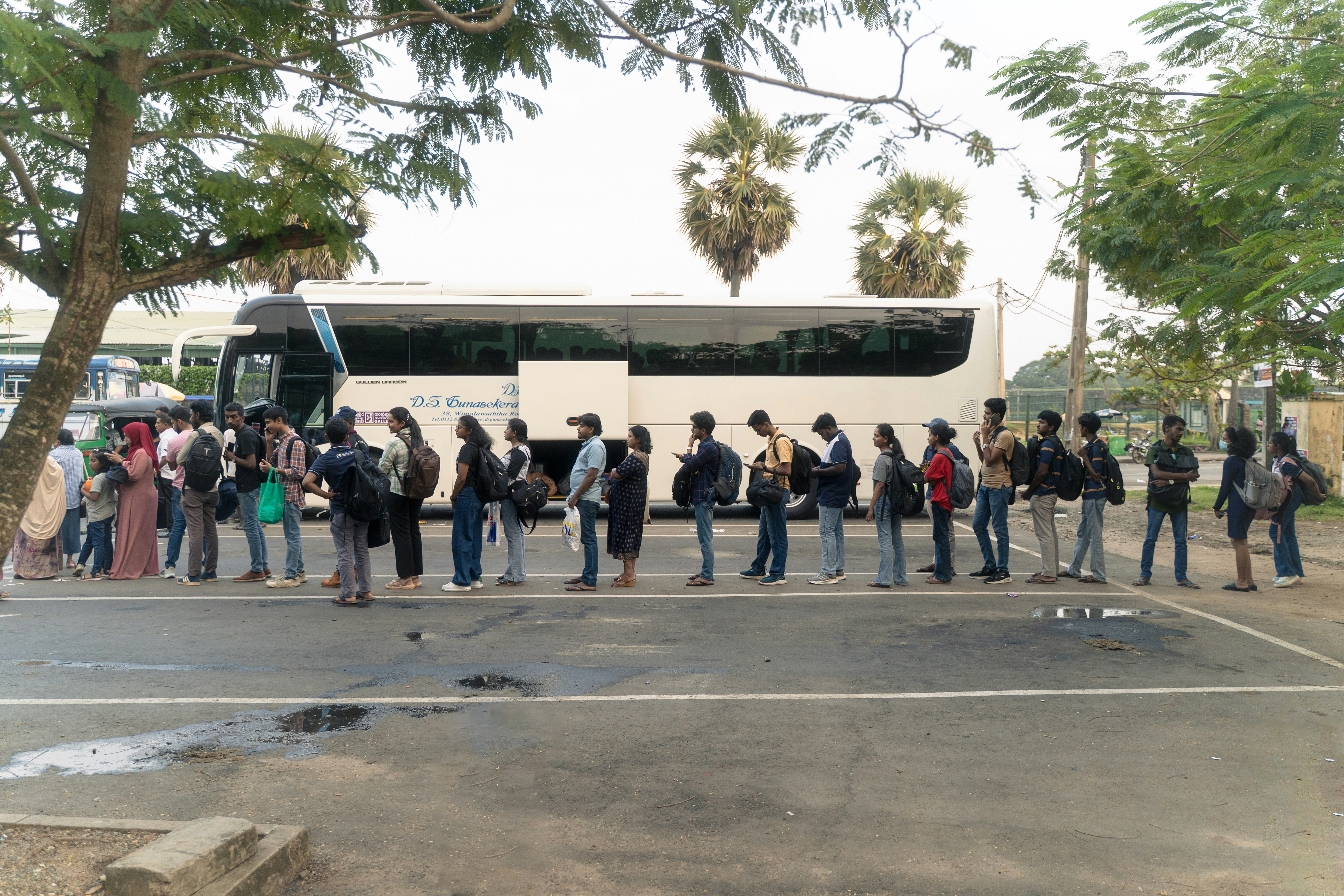 People waiting in line for a bus.