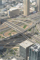 Complex highway interchange with skyscrapers in a city.