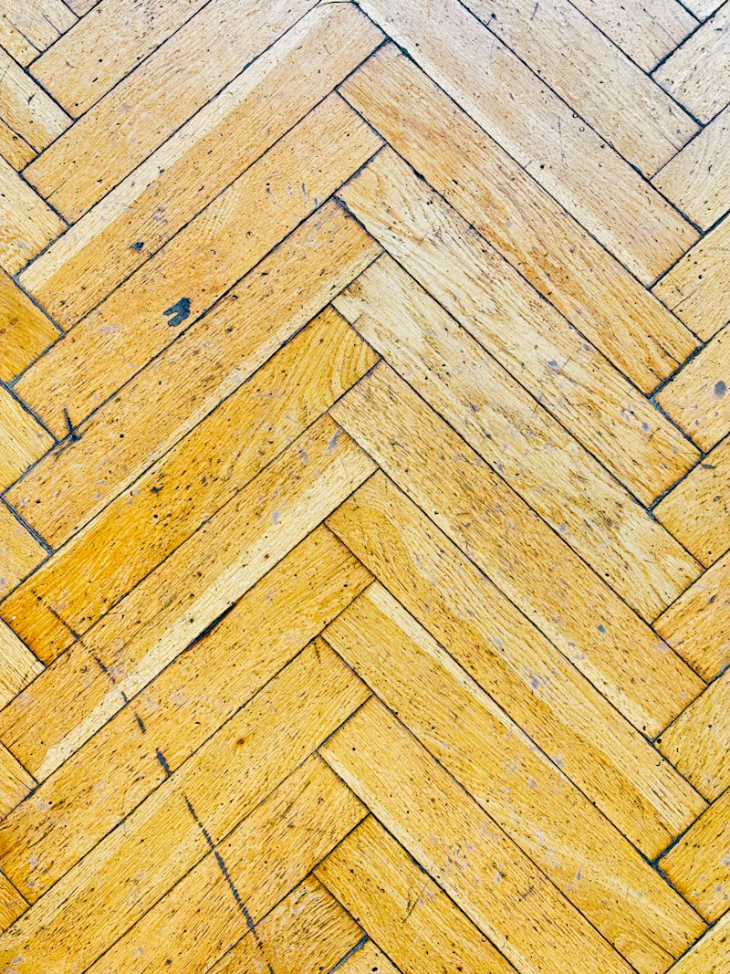 Close-up of herringbone wood pattern laminate floor