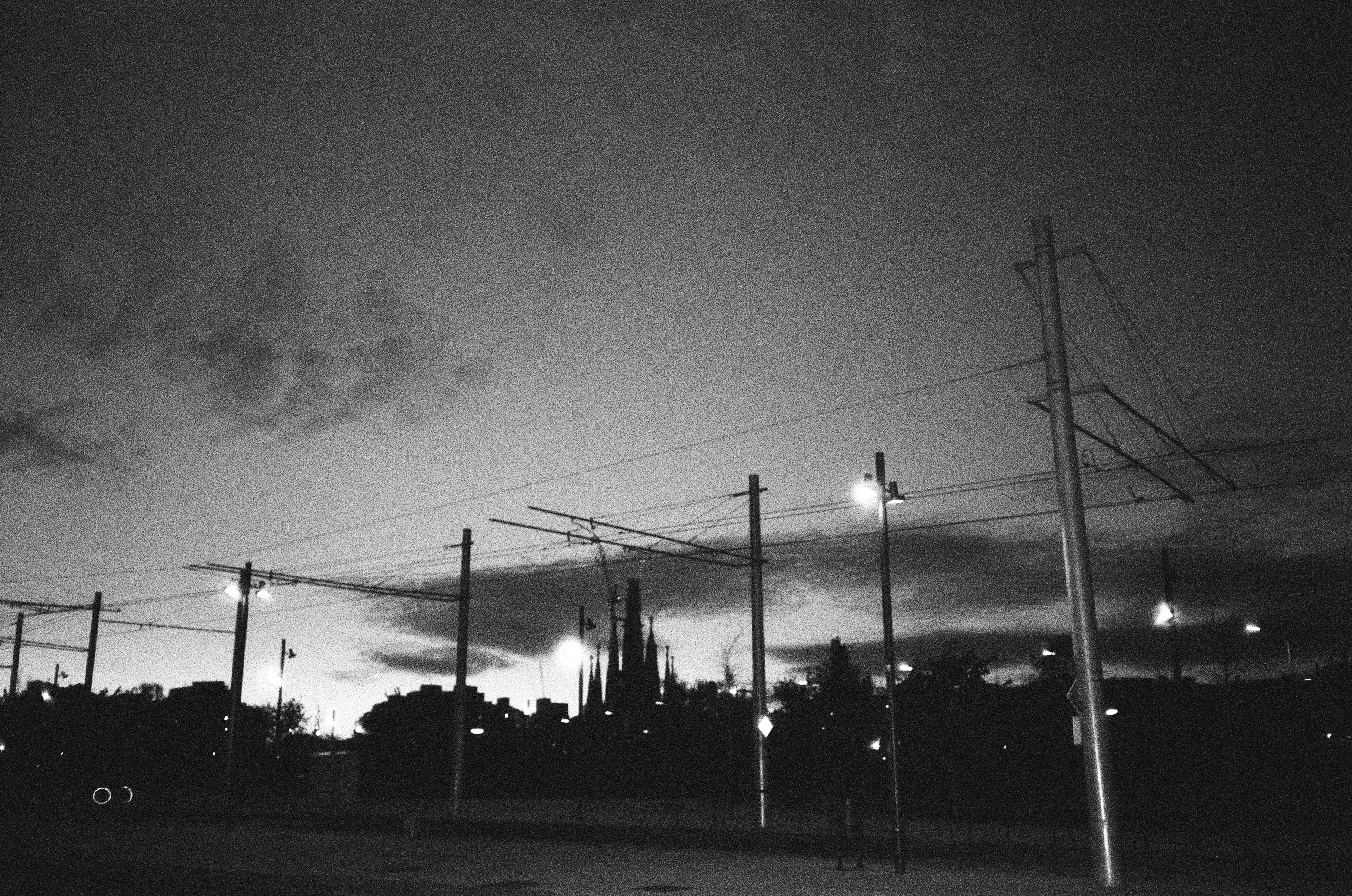 City skyline with overhead wires at dusk