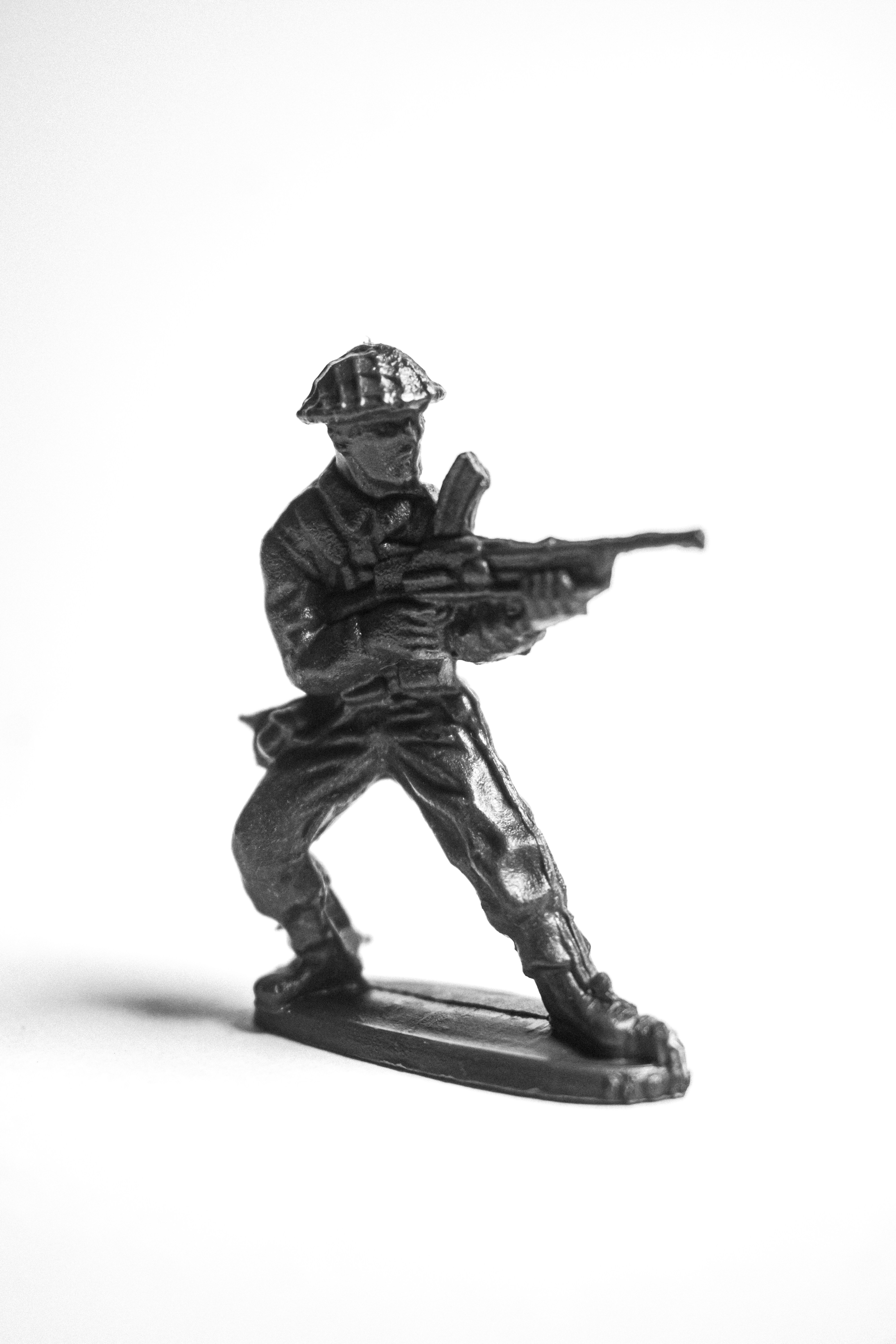 A black and white toy soldier holding a rifle.