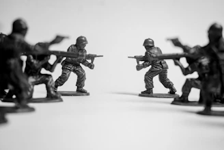 Toy soldiers in a standoff on a white background