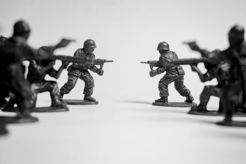 Toy soldiers in a standoff on a white background