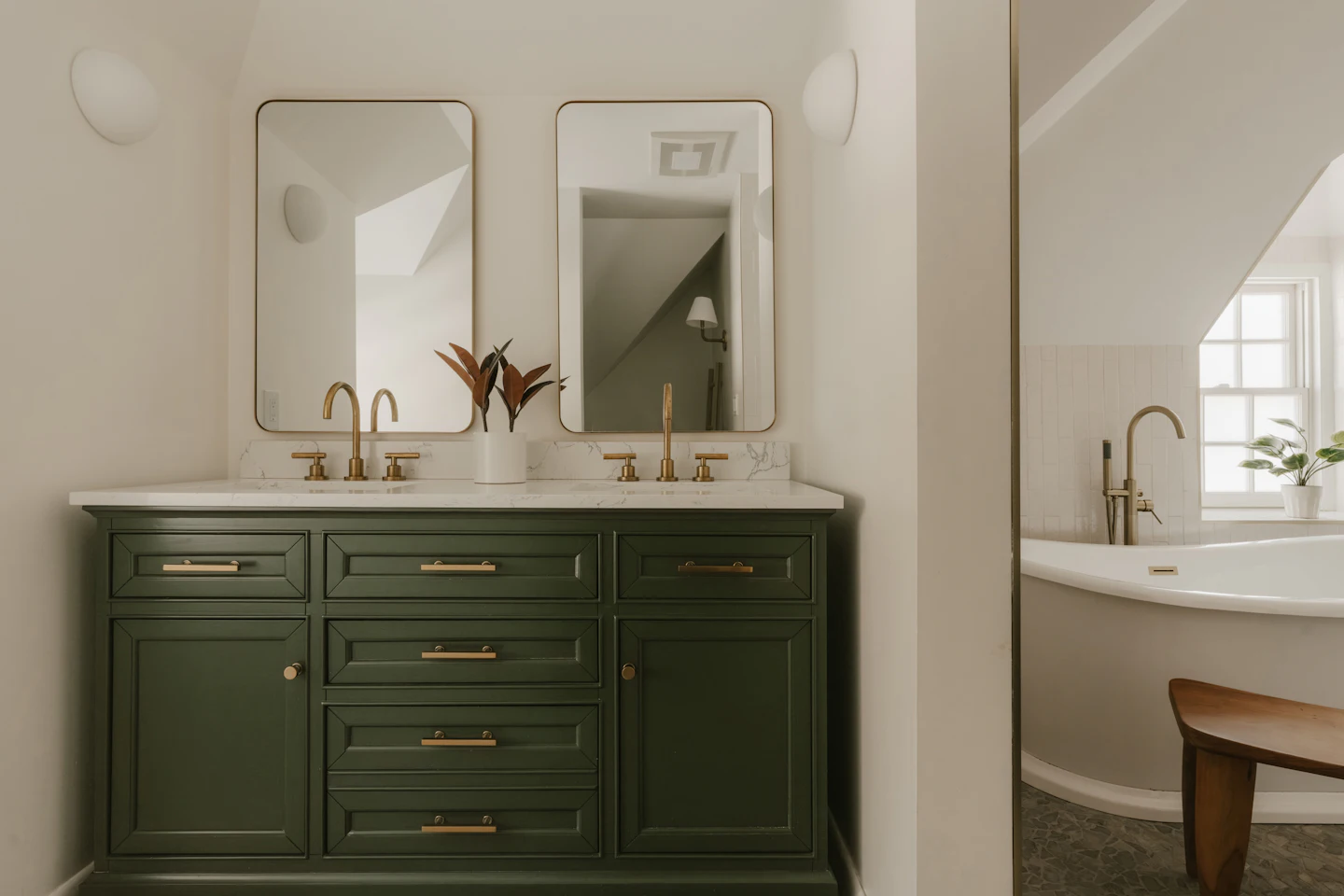 Green double vanity with two sinks, brass faucets and mirrors