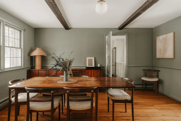 A rustic dining room with wooden table and chairs.
