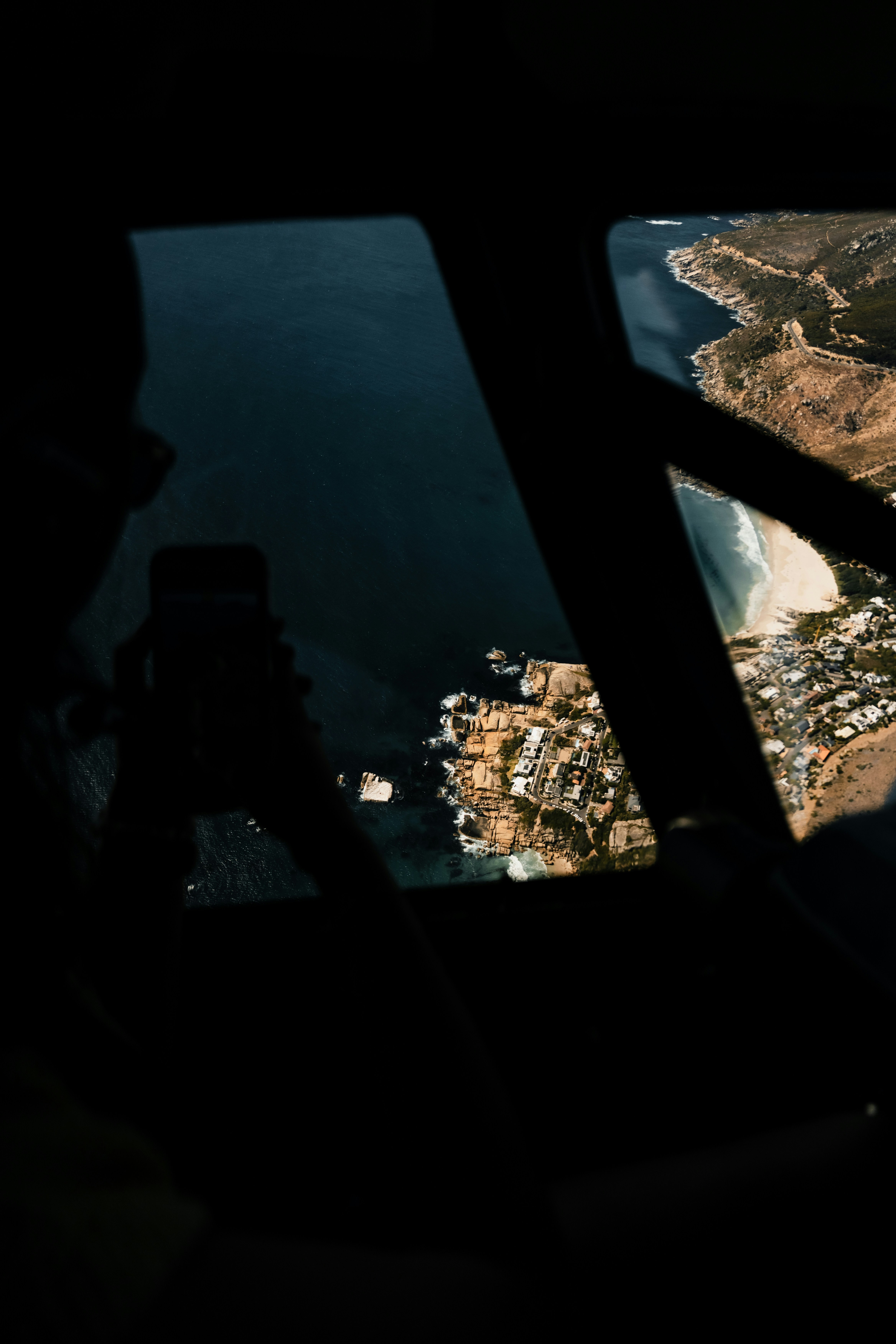 Aerial view of a coastal town from an airplane window