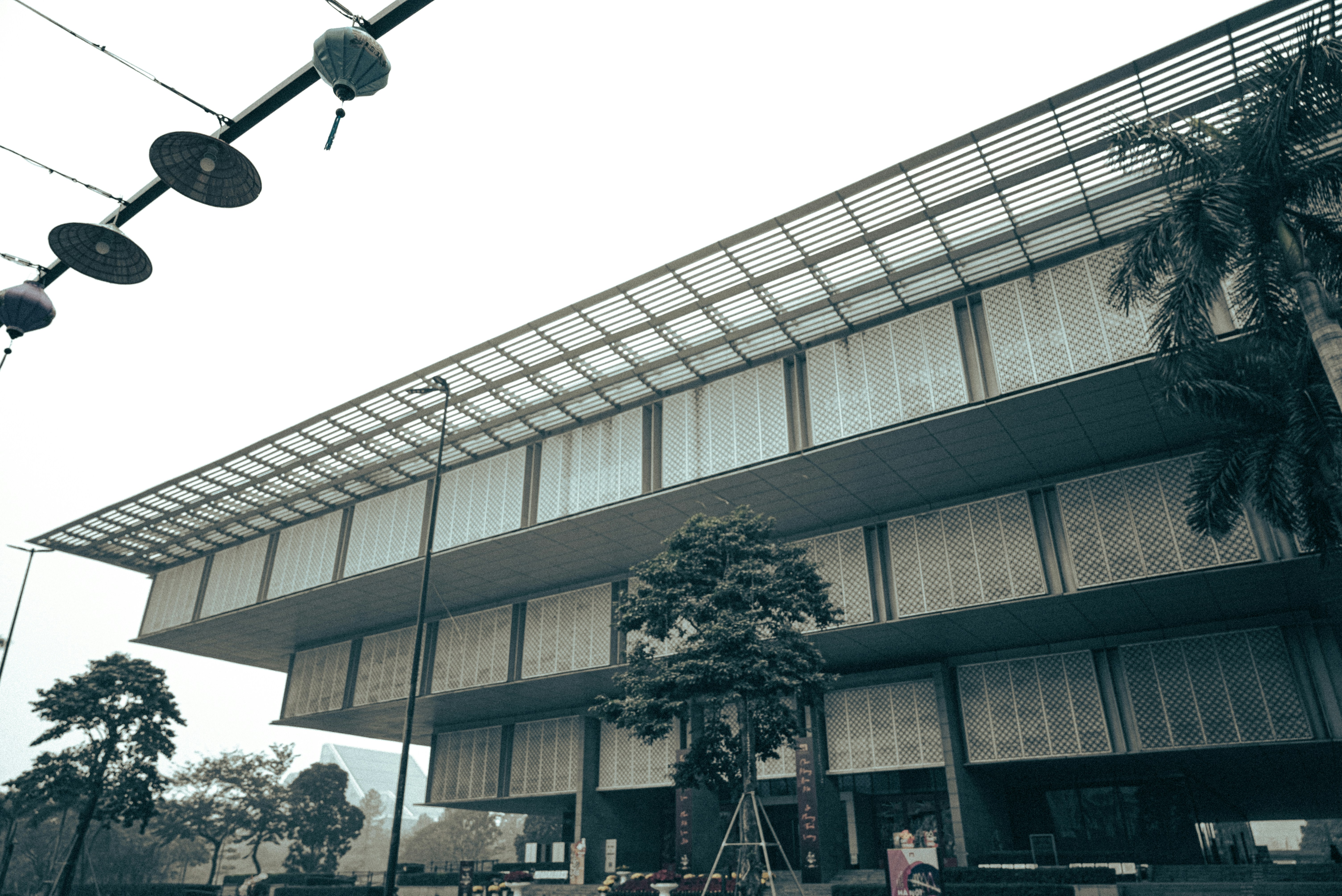 Modern building with glass roof and trees