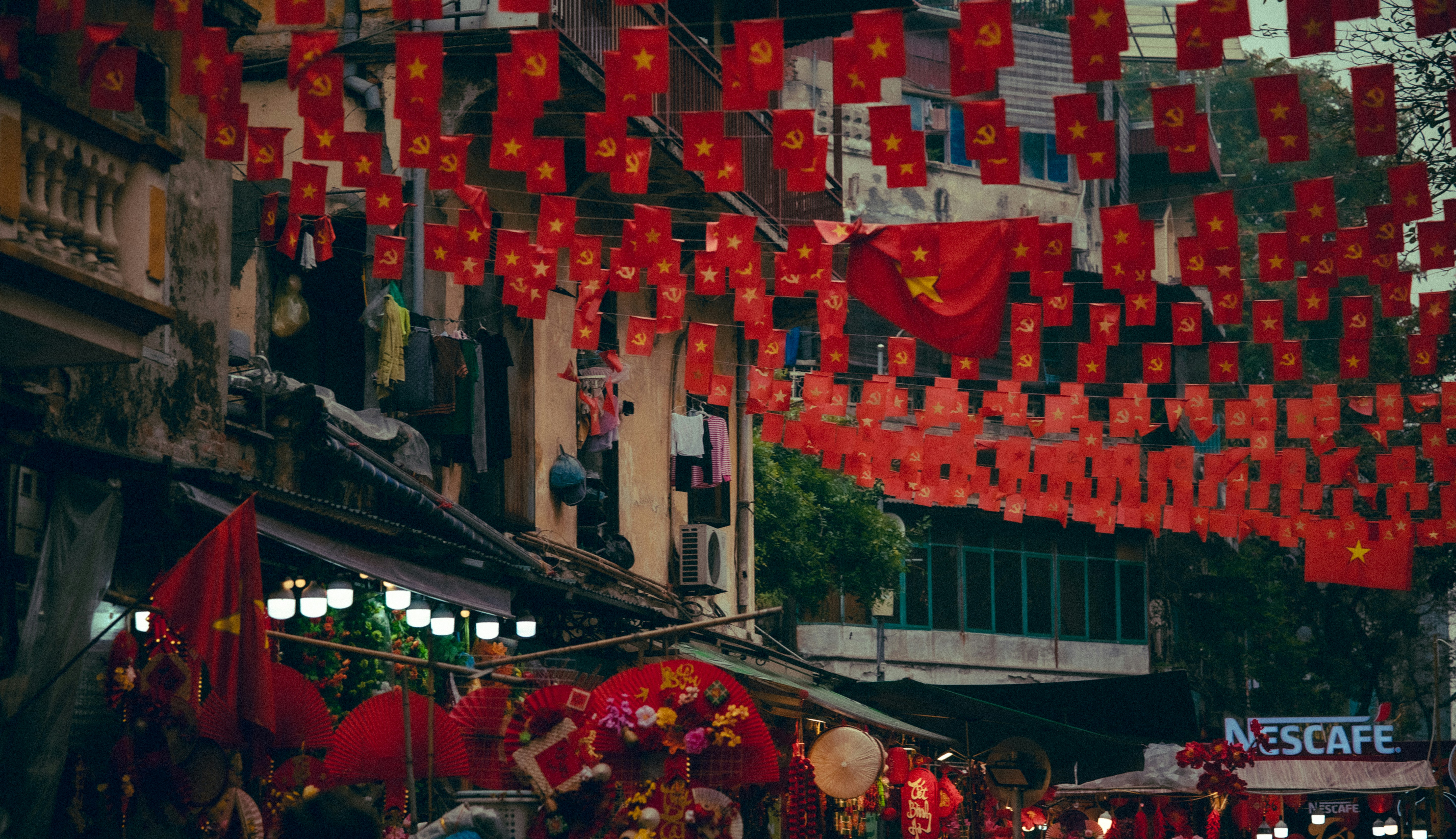 Street decorated with many red lanterns and flags