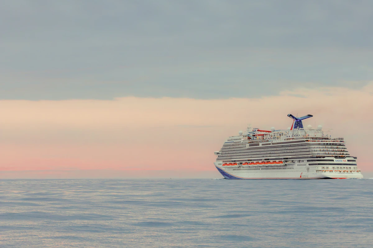 A large cruise ship sails on the calm ocean