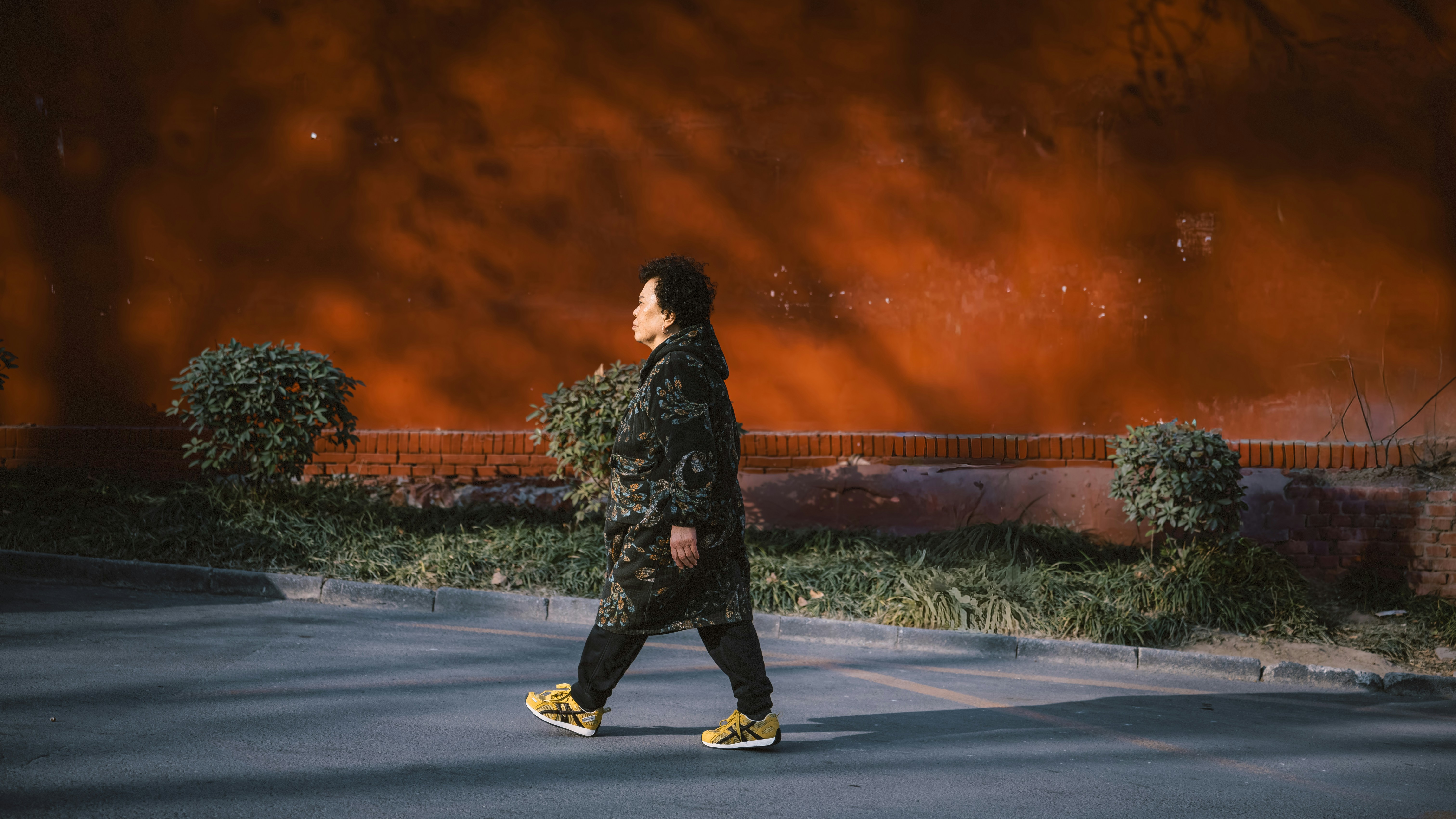 Woman walking at night with illuminated background