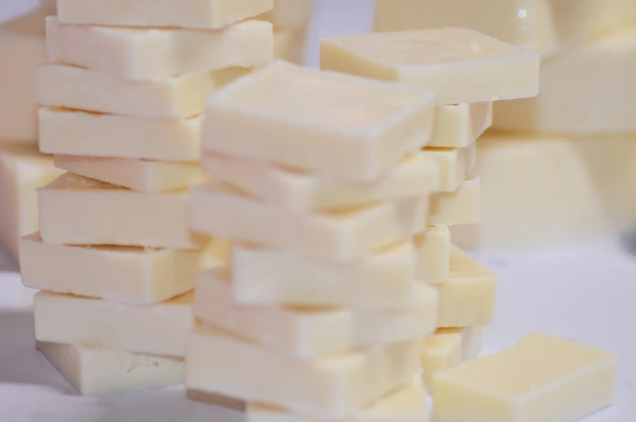 Pale ivory blocks of cooled shea butter stacked before packing