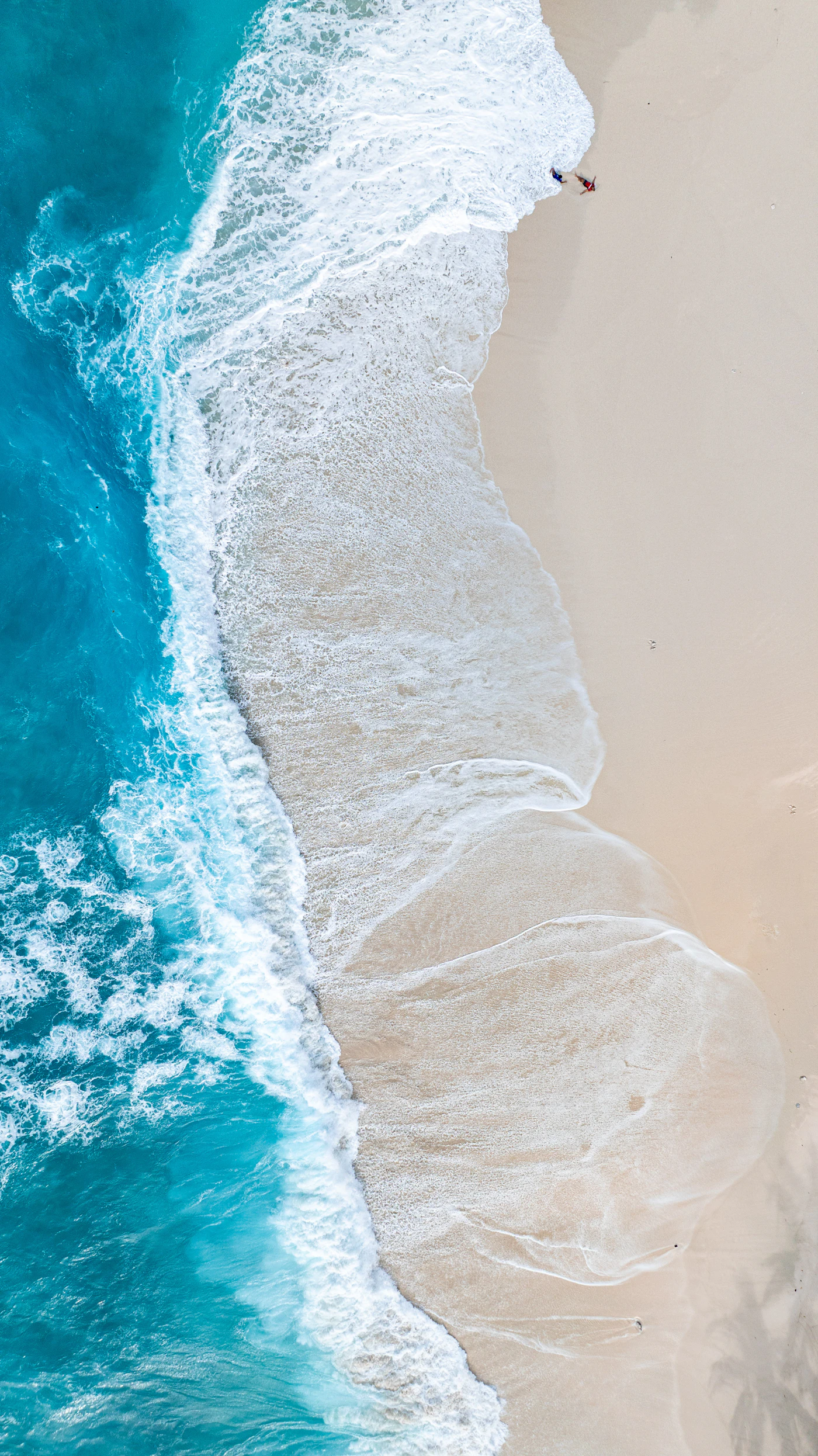 Aerial view of turquoise Caribbean ocean water and coastline, representing the region CARICOM's AI governance push is meant to cover
