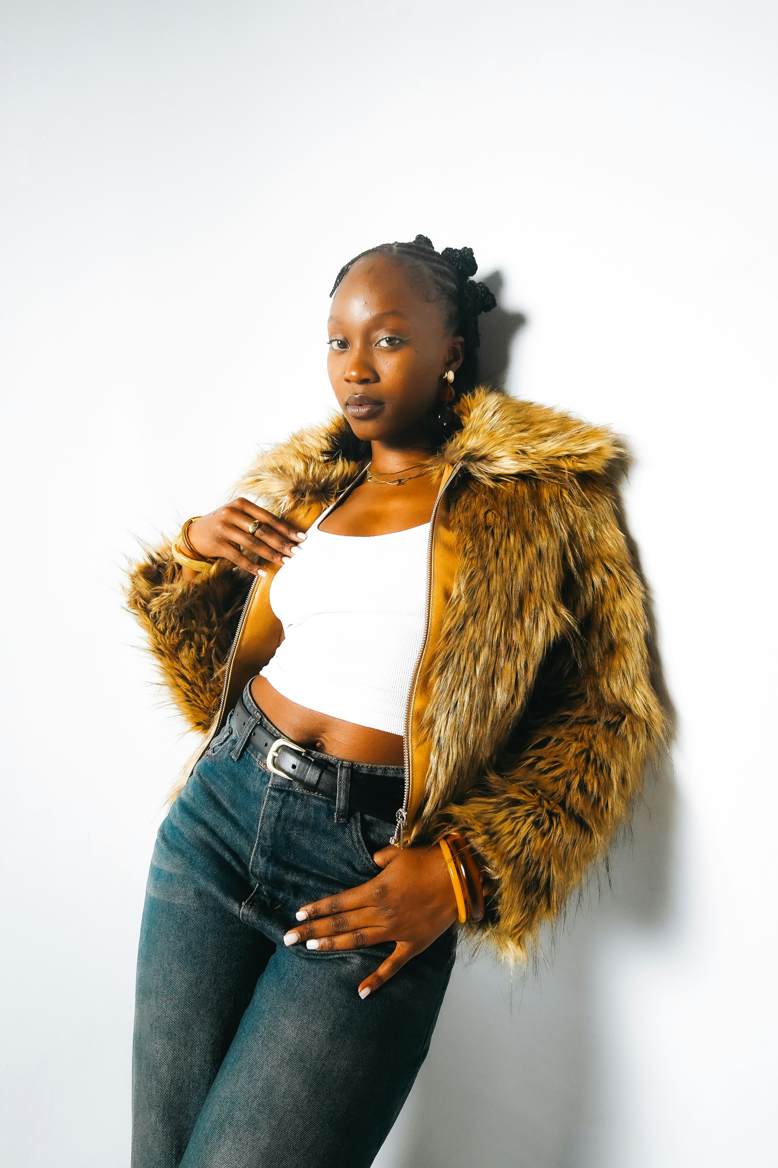 Young woman in a faux fur jacket and jeans