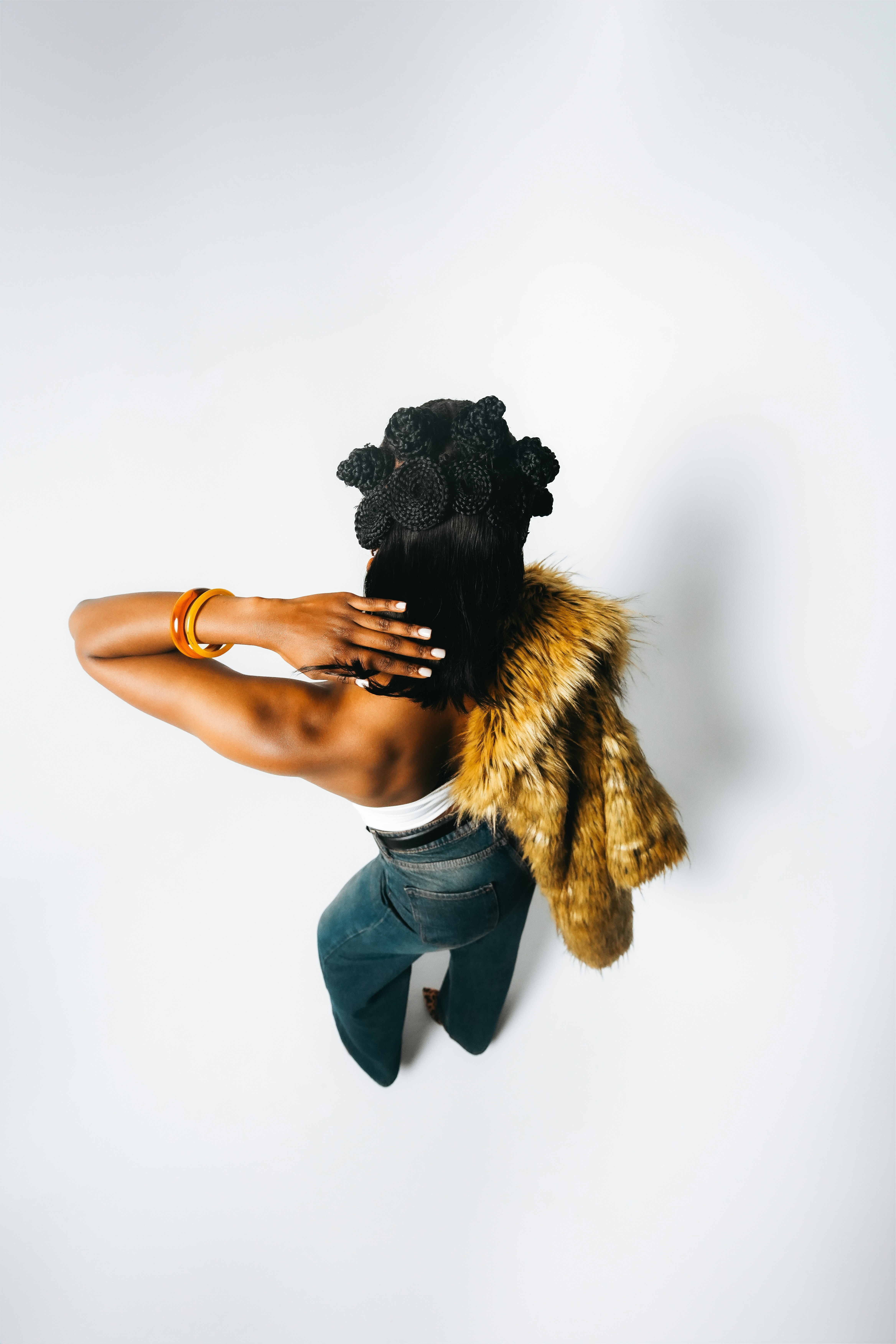 Woman with fur stole and jeans from above