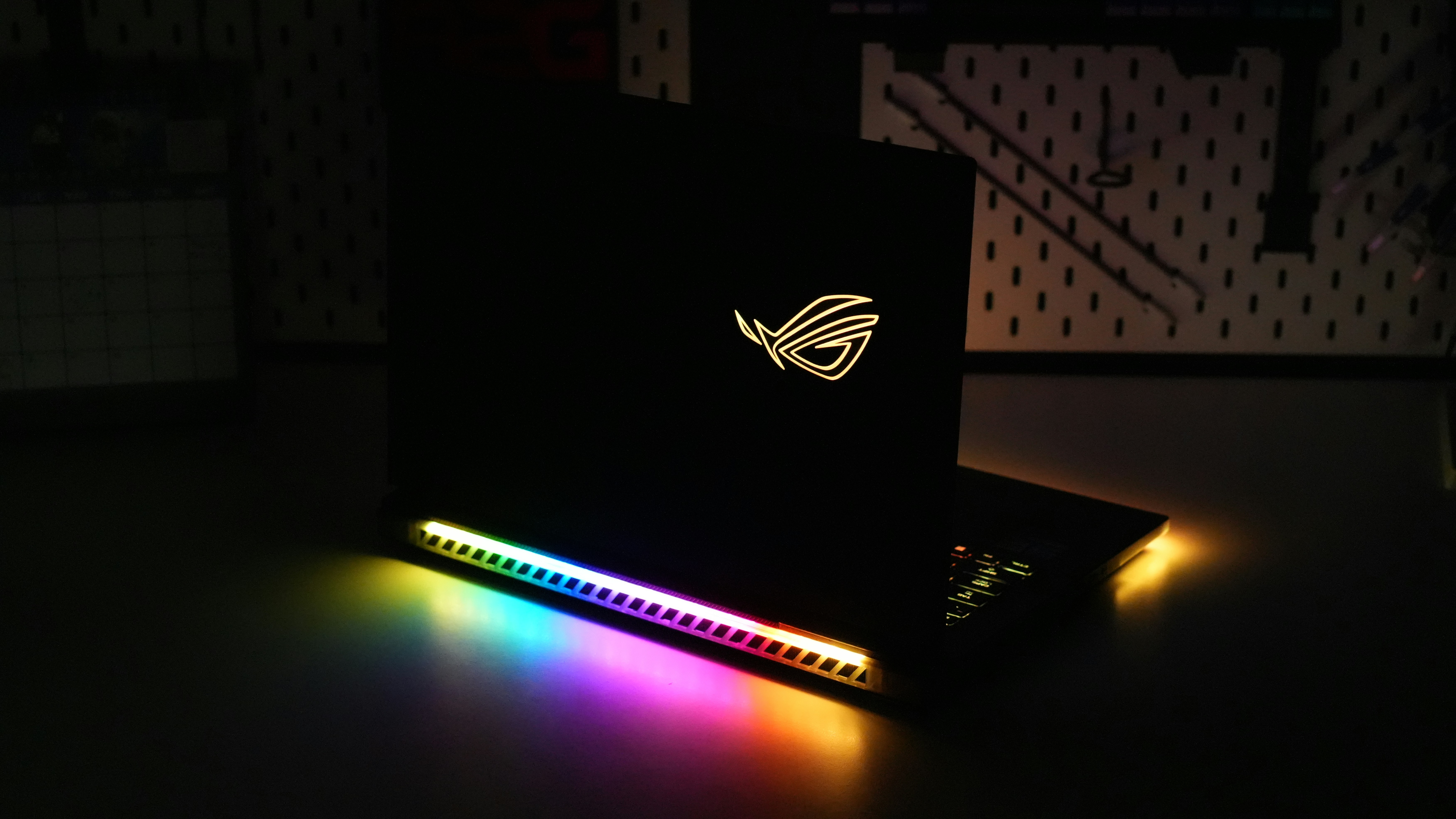 Black laptop with colorful rgb lighting in dark room