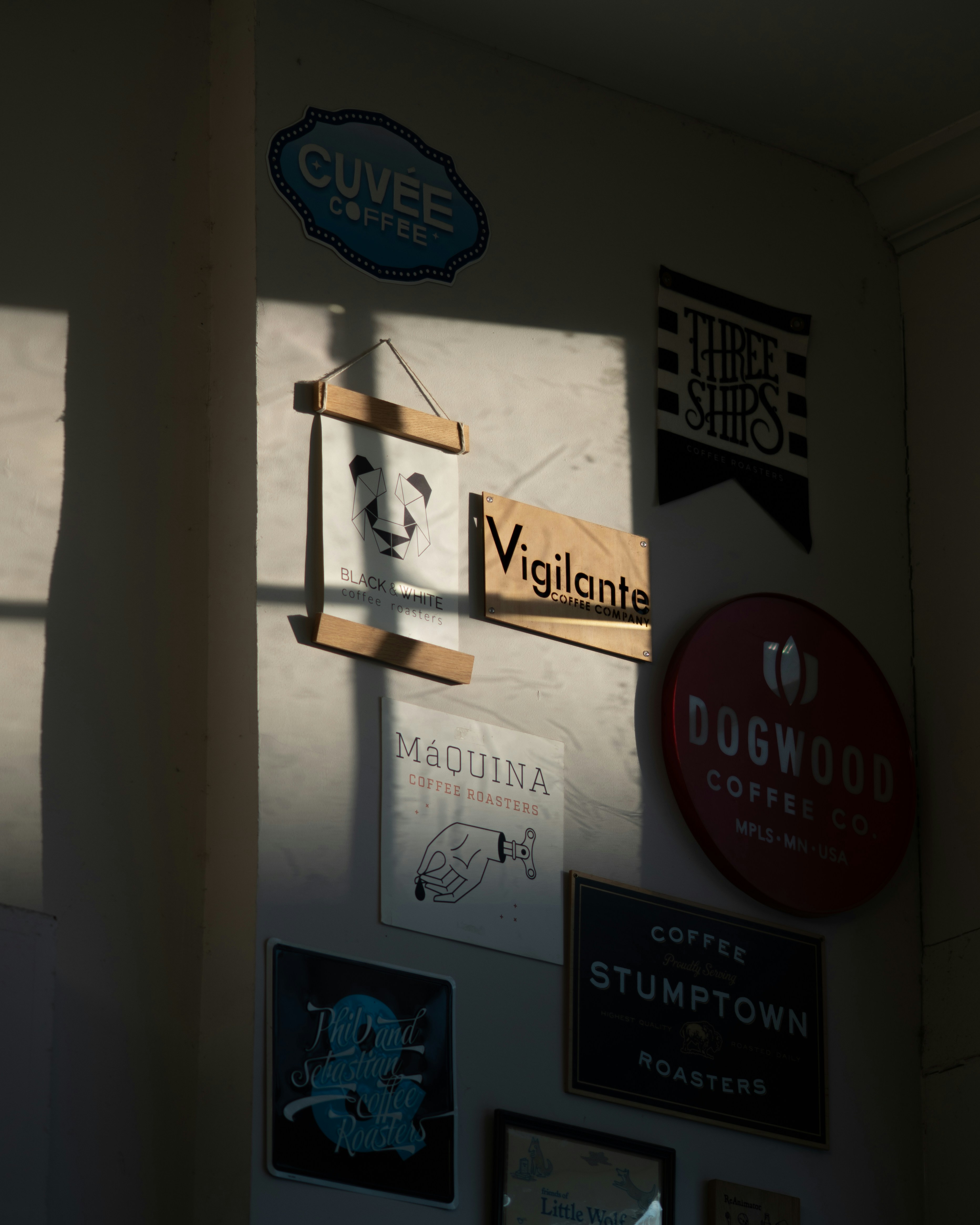 Various coffee shop signs on a wall.