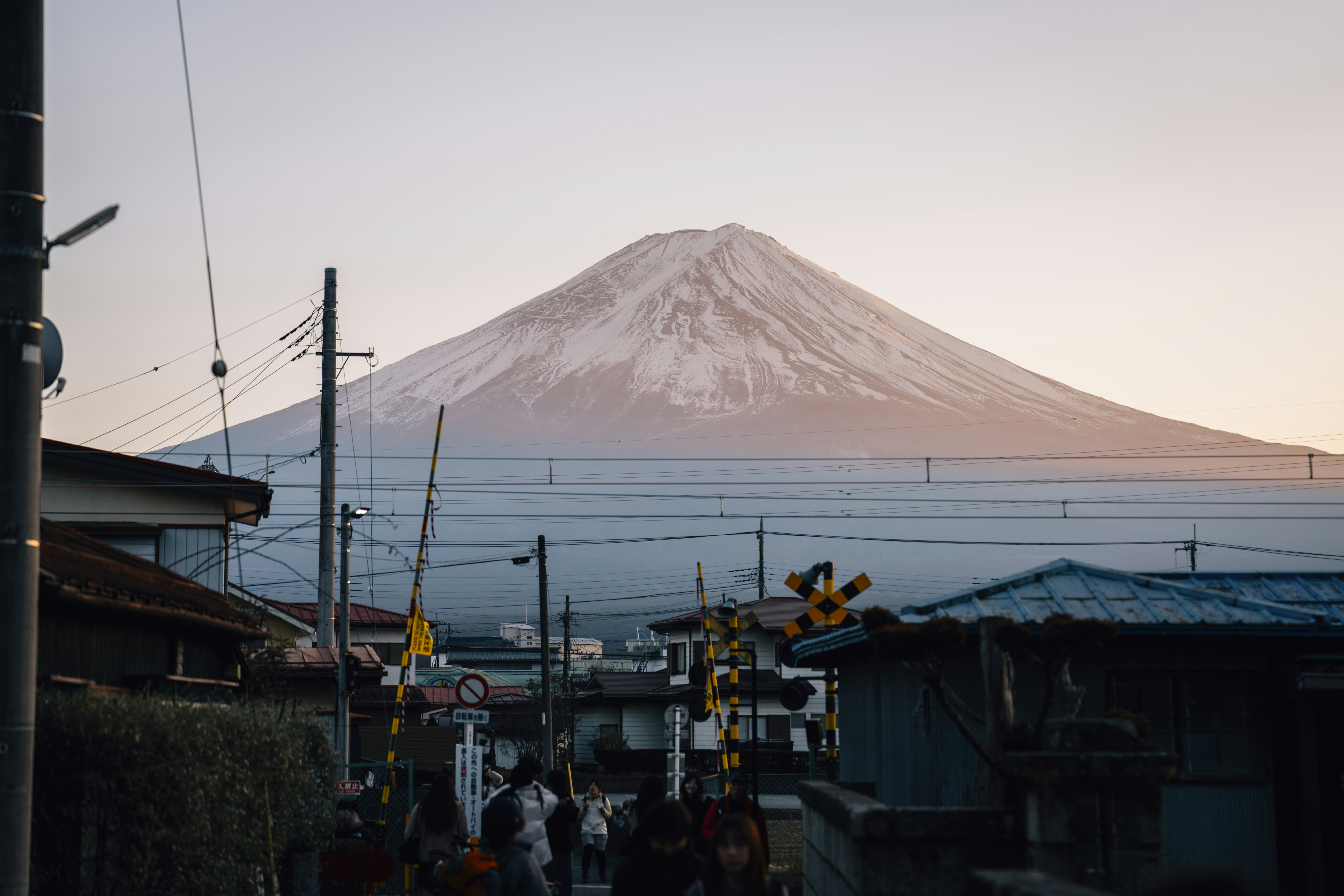 Mount fuji seen over houses and train tracks