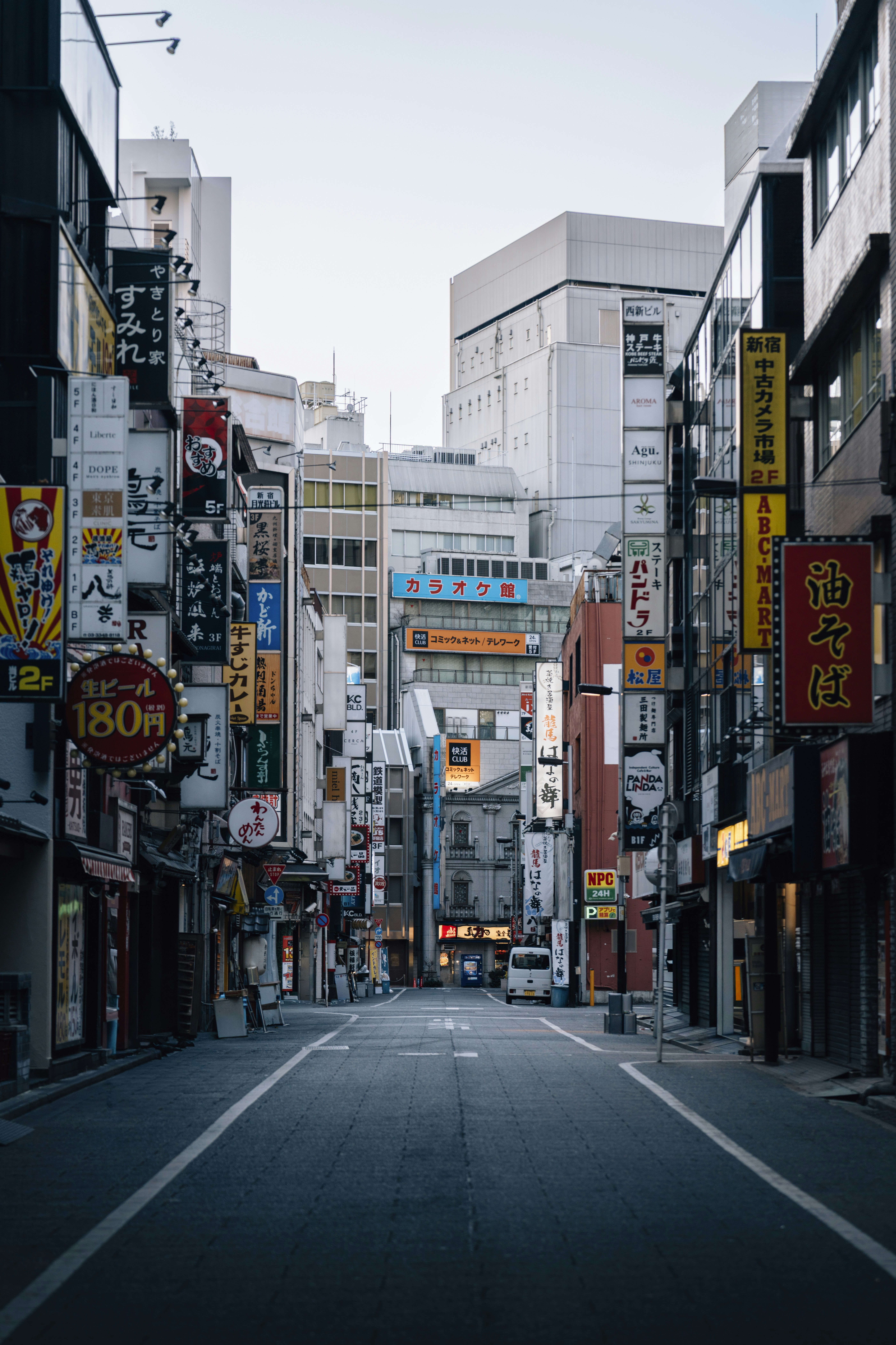 Empty street lined with buildings and signs