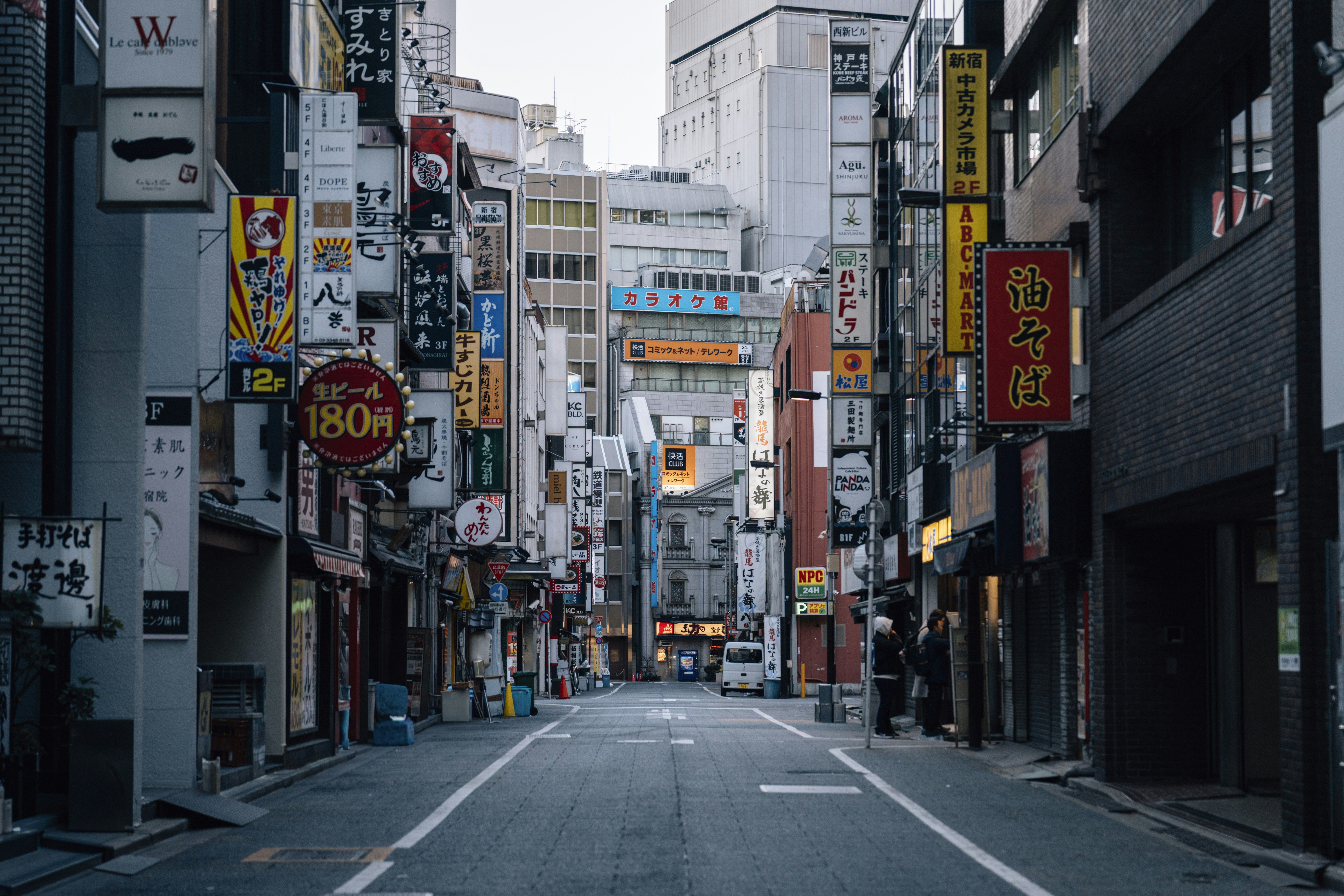 Empty street in a japanese city with many signs