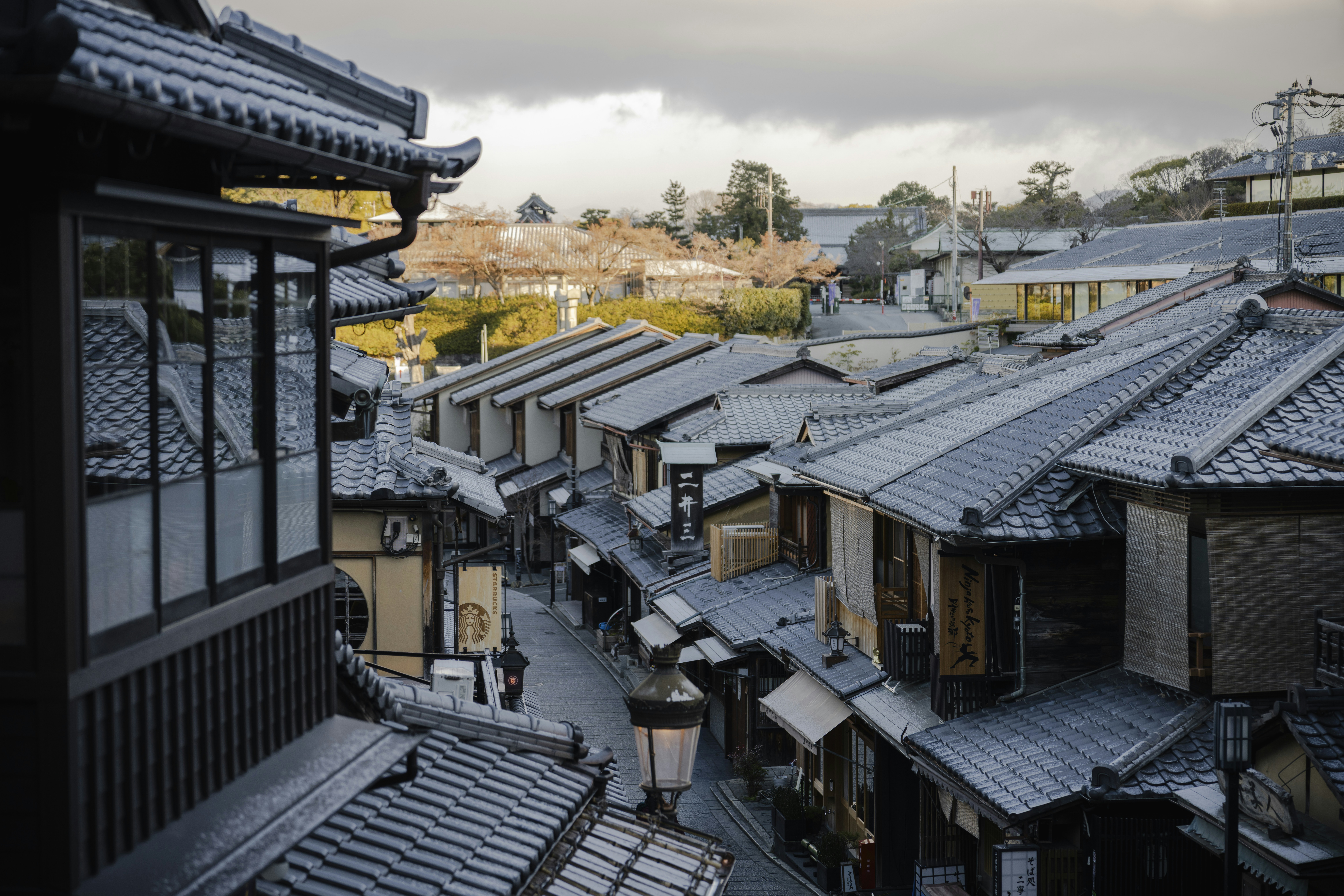 Traditional japanese street with tiled roofs and wooden houses.